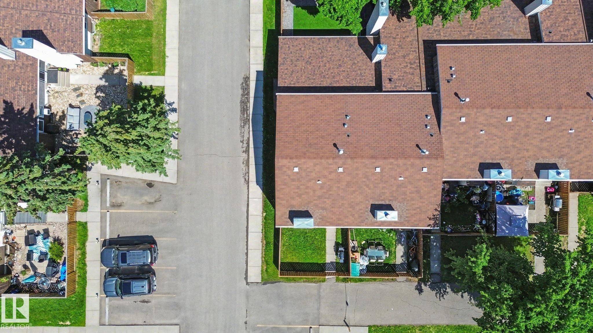 Aerial perspective showcasing multiple properties with brown shingle roofing - 18409 66 Avenue, Edmonton, AB