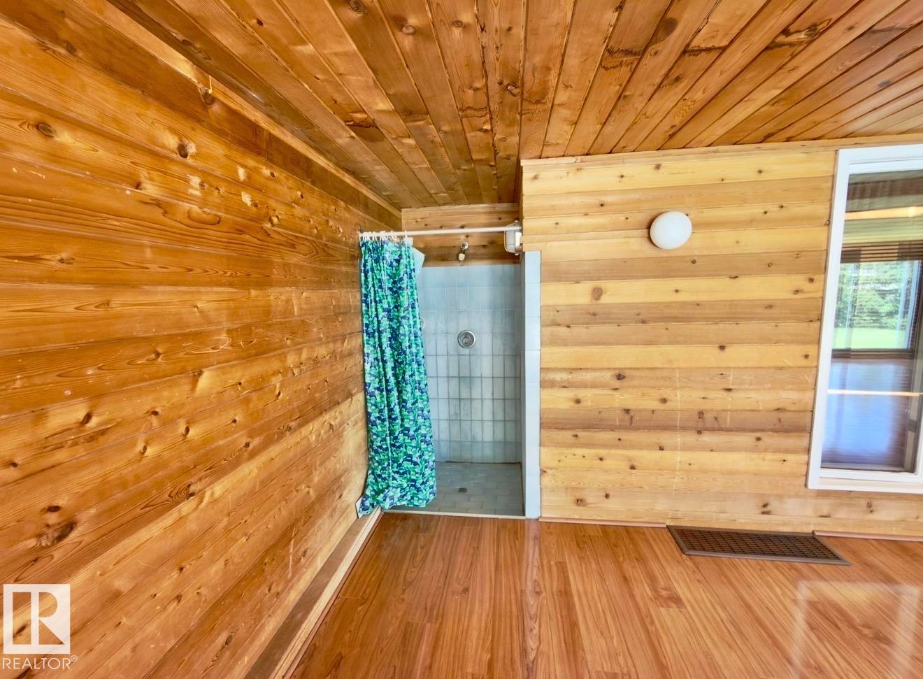 Wood-finish flooring with plank-style wall and ceiling paneling - 134 Wolf Ridge Place, Edmonton, AB