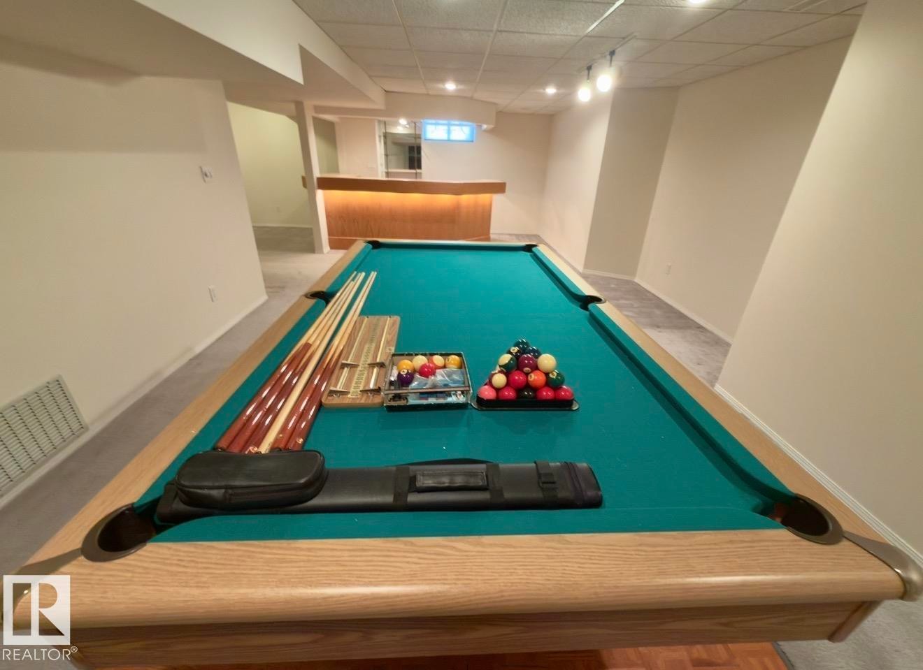 Finished basement featuring a built-in bar, recessed lighting, and carpet flooring - 134 Wolf Ridge Place, Edmonton, AB