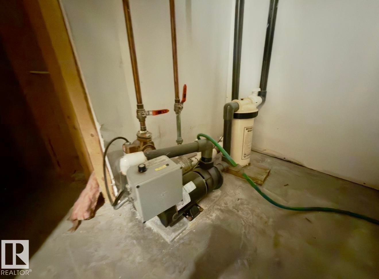 Water filtration system with associated plumbing, copper piping, and a concrete floor - 134 Wolf Ridge Place, Edmonton, AB