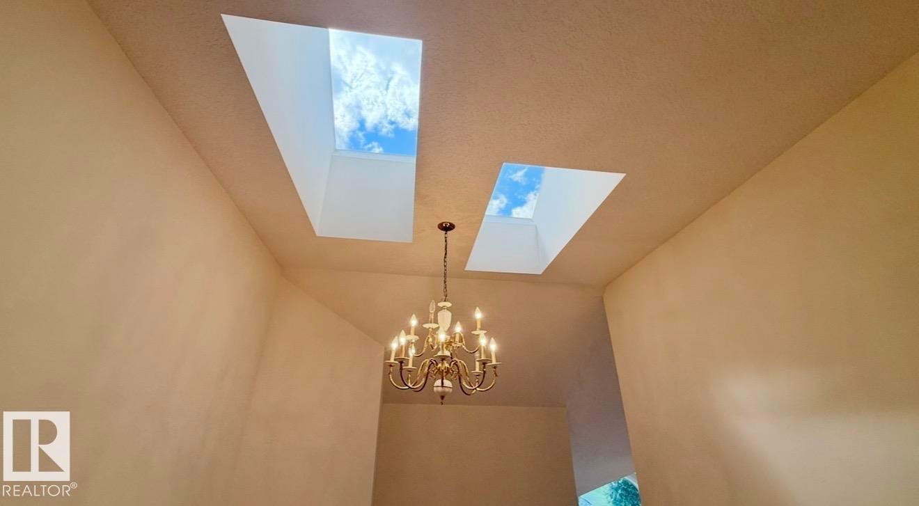 Soaring ceilings featuring two skylights and a multi-arm chandelier - 134 Wolf Ridge Place, Edmonton, AB