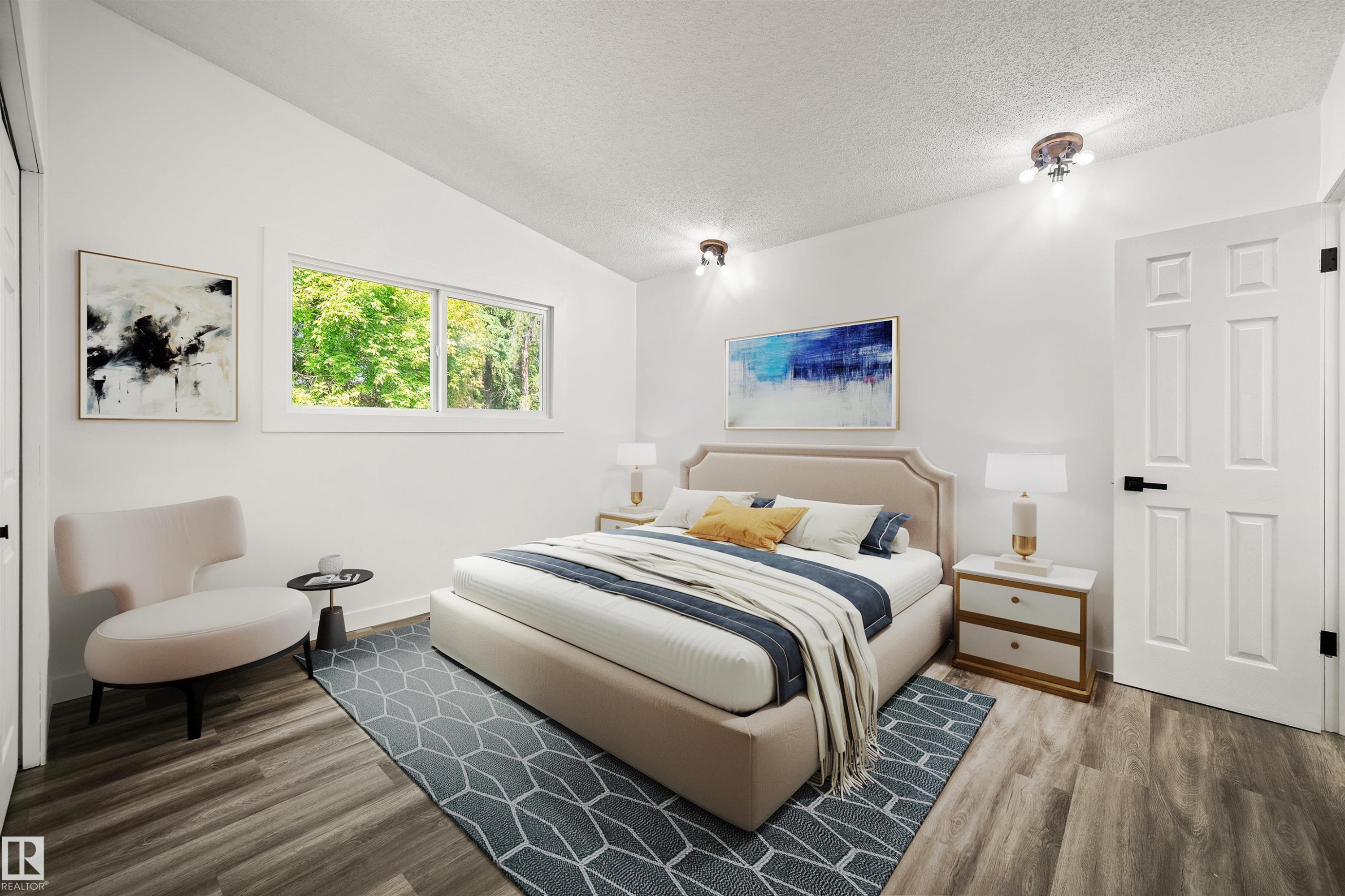 Spacious bedroom featuring vaulted ceilings, wood-finish flooring, a large horizontal window, white paneled doors, and ceiling-mounted lighting fixtures - 28 Goodridge Drive, St. Albert, AB