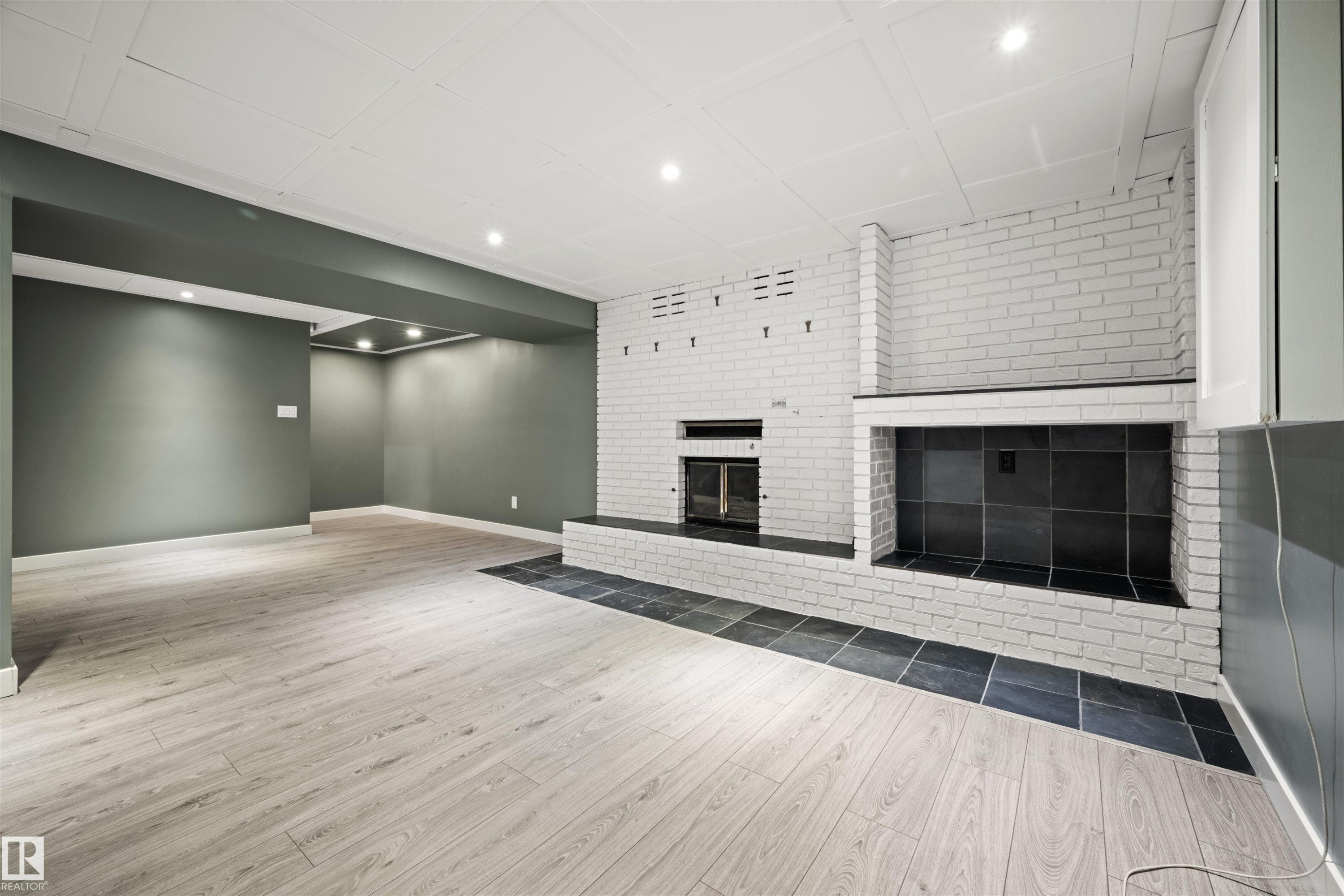 Finished lower-level space featuring light wood-finish flooring and recessed lighting - 28 Goodridge Drive, St. Albert, AB