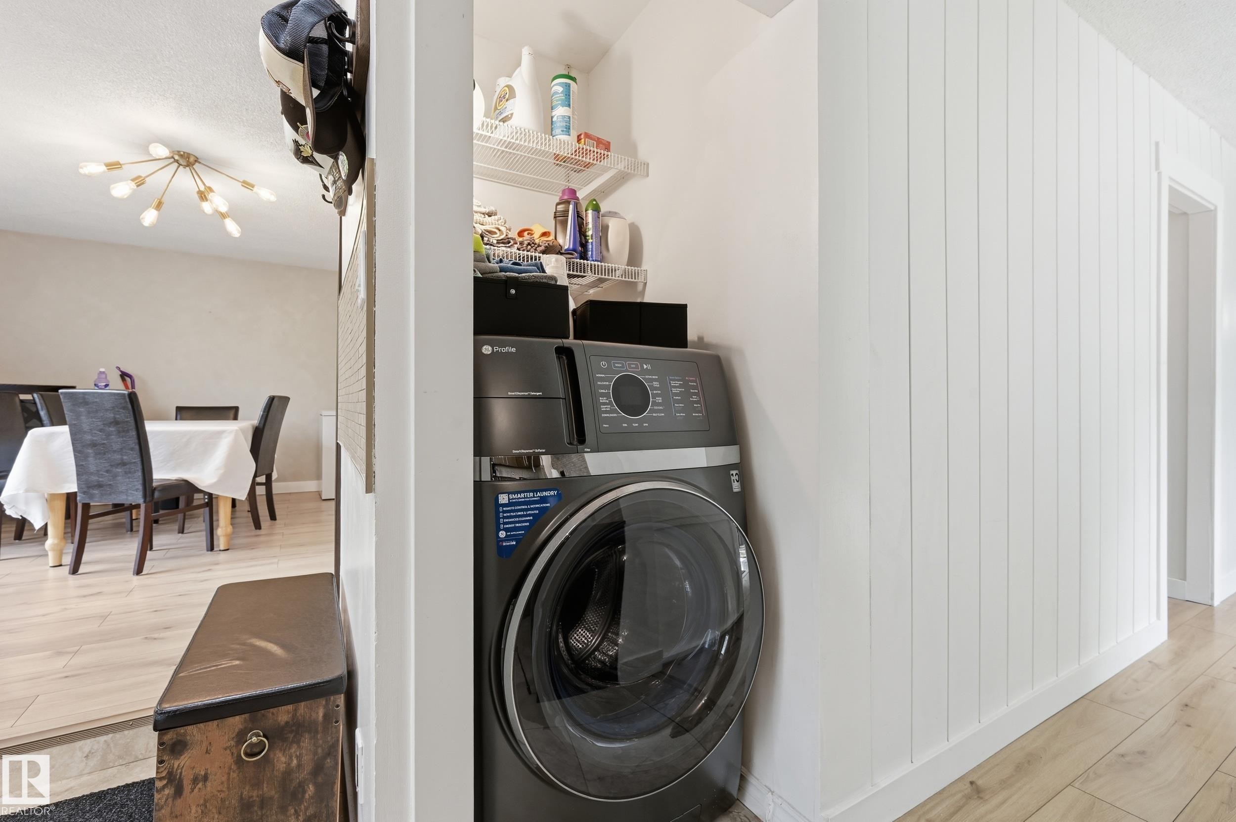 Dedicated laundry area featuring a stacked washer and dryer unit - 12326 92 Street, Edmonton, AB - Indoor Photo Showing Laundry Room