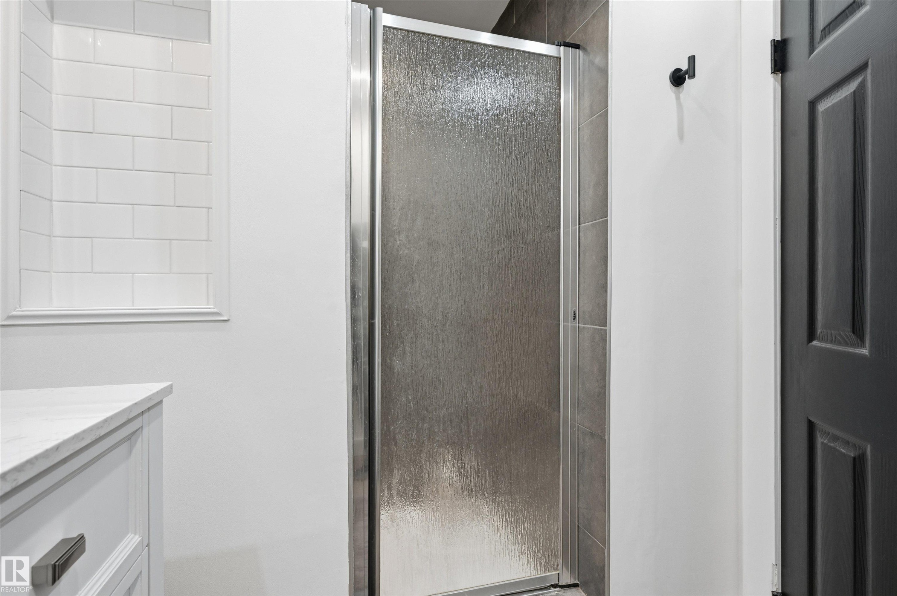 Frosted glass shower enclosure with chrome hardware - 12326 92 Street, Edmonton, AB - Indoor Photo Showing Bathroom