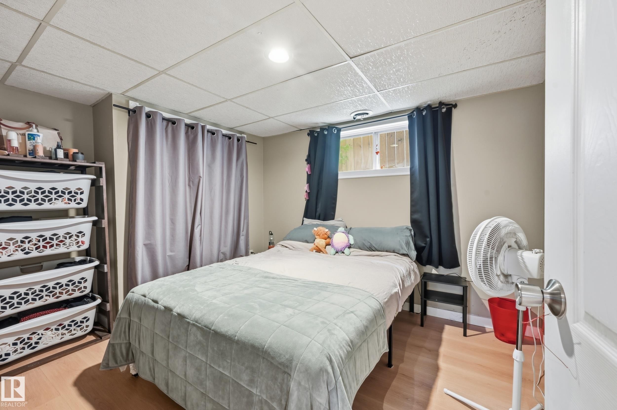 Light wood-finish flooring complements the neutral wall tones - 12326 92 Street, Edmonton, AB - Indoor Photo Showing Bedroom