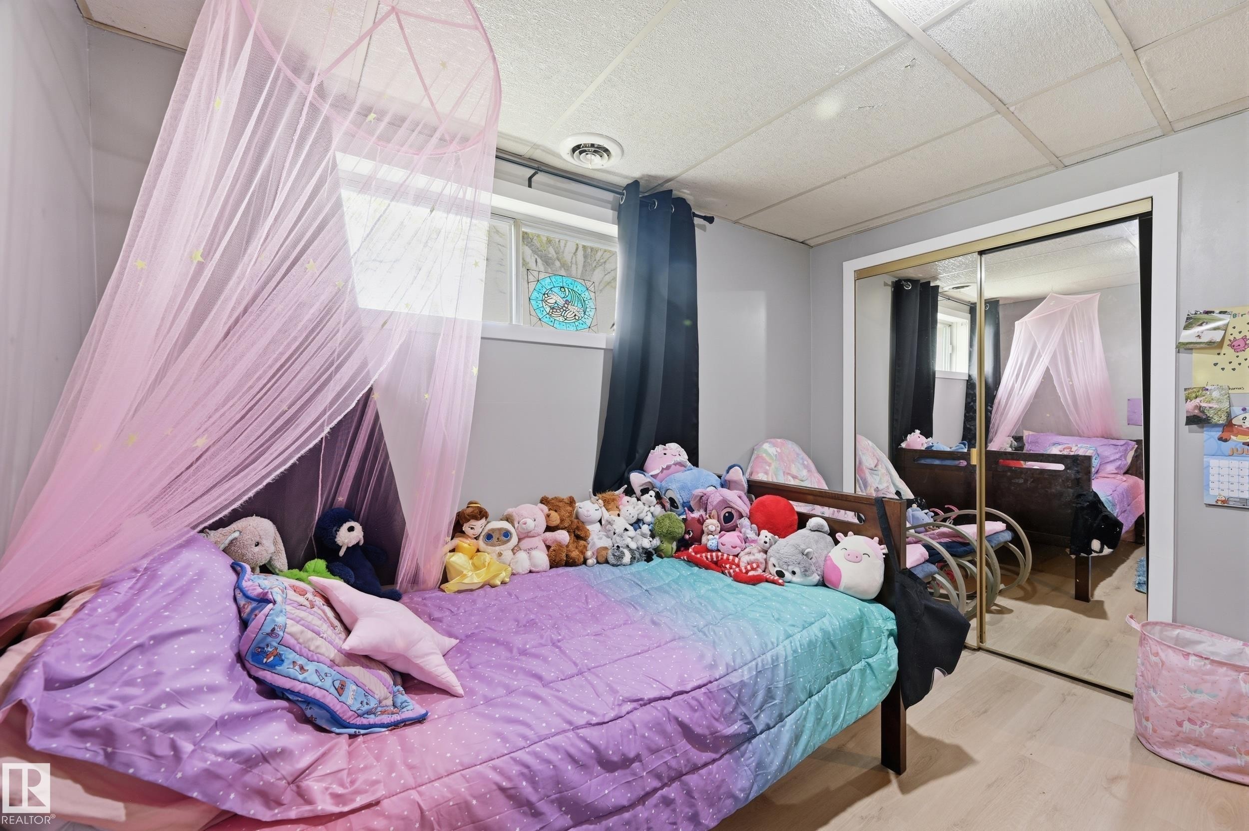 Room featuring light-toned walls, a drop ceiling, and light wood-finish flooring - 12326 92 Street, Edmonton, AB - Indoor Photo Showing Bedroom