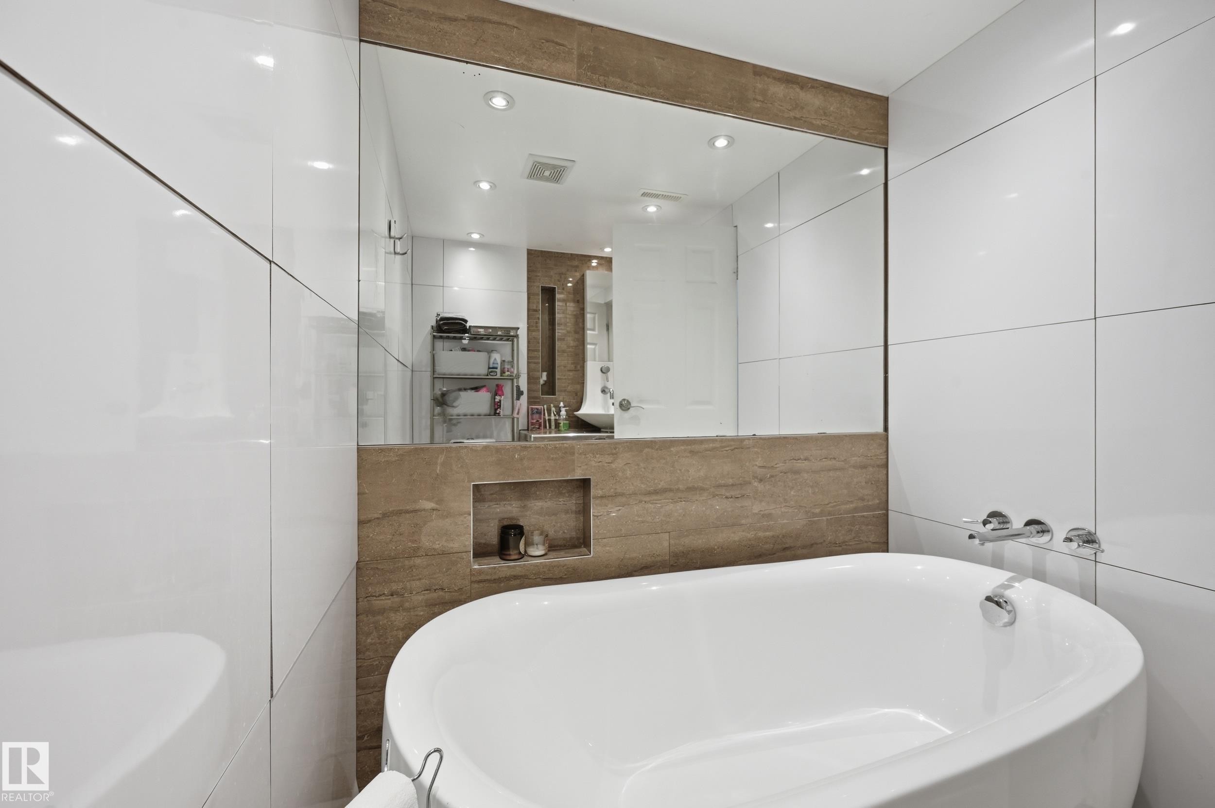 Freestanding soaking tub with chrome wall-mounted fixtures - 12326 92 Street, Edmonton, AB - Indoor Photo Showing Bathroom