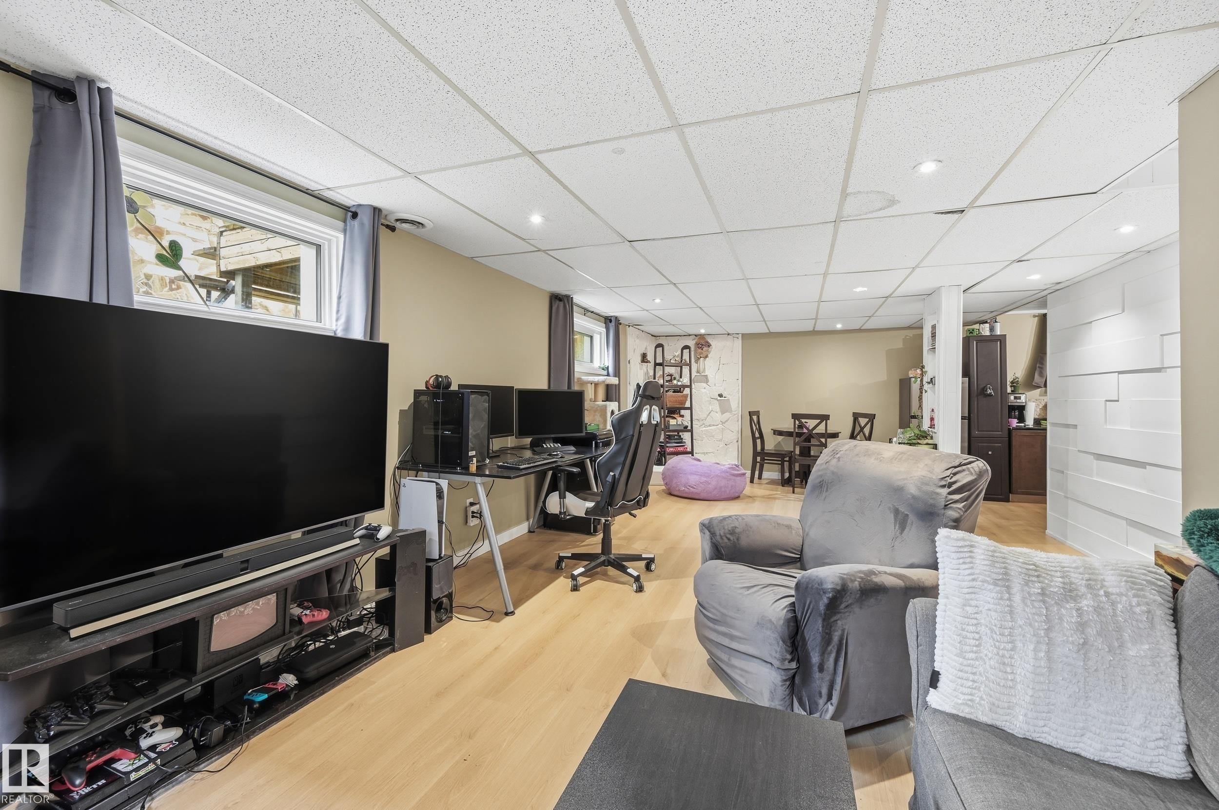 Open-concept space featuring light wood-finish flooring and recessed lighting - 12326 92 Street, Edmonton, AB - Indoor