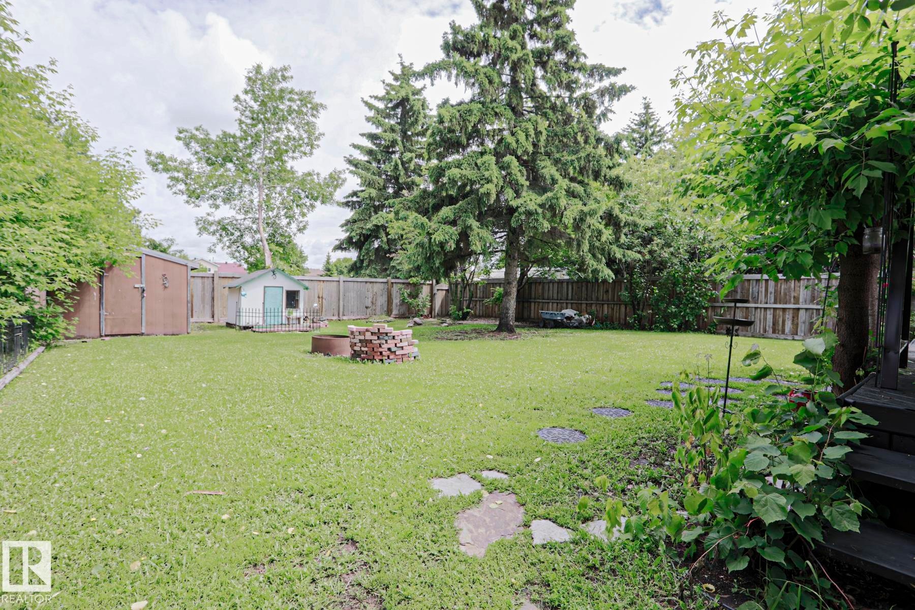 Expansive backyard featuring a lush lawn and mature trees - 2007 67 Street, Edmonton, AB