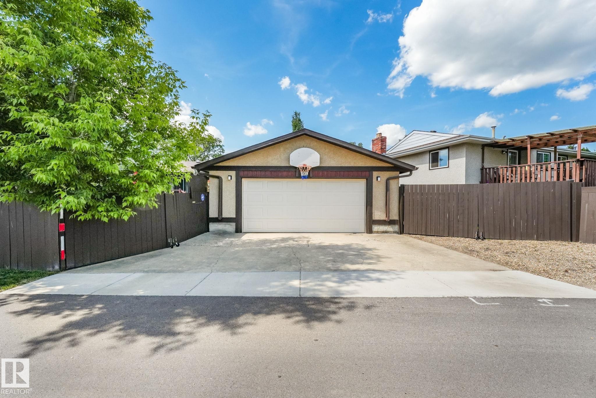 Attached garage with a white overhead door and basketball hoop - 17237 104 Street, Edmonton, AB