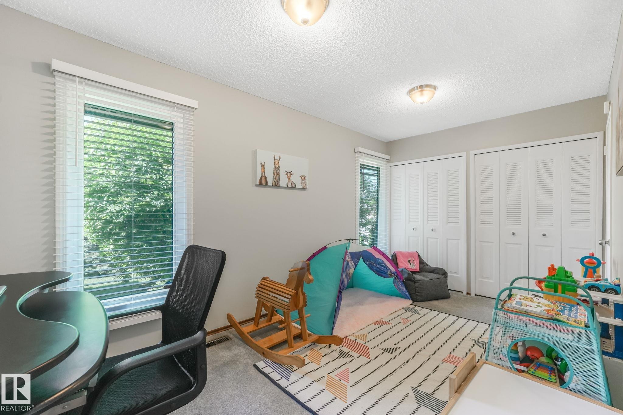 Room featuring neutral wall tones, textured ceiling, and two ceiling-mounted light fixtures - 17237 104 Street, Edmonton, AB