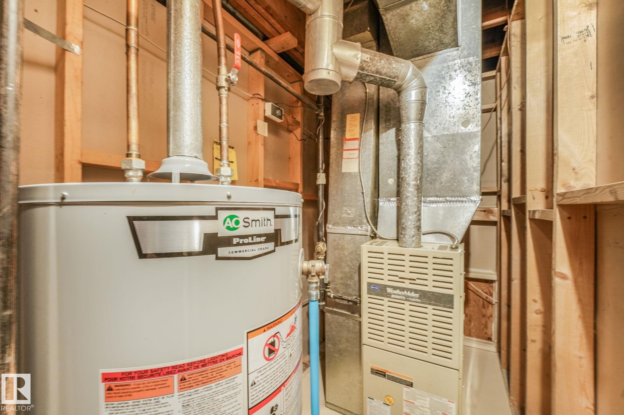 Utility area featuring a water heater and furnace unit - 17237 104 Street, Edmonton, AB