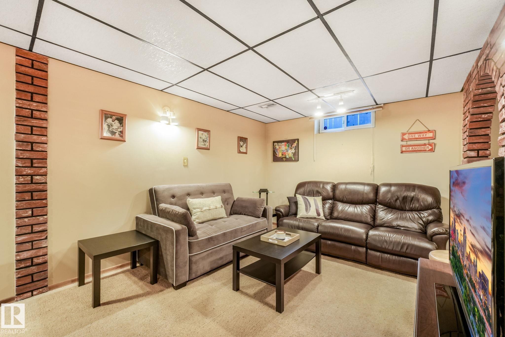 Recessed lighting and a drop ceiling complement the light-colored walls and carpeted flooring - 17237 104 Street, Edmonton, AB