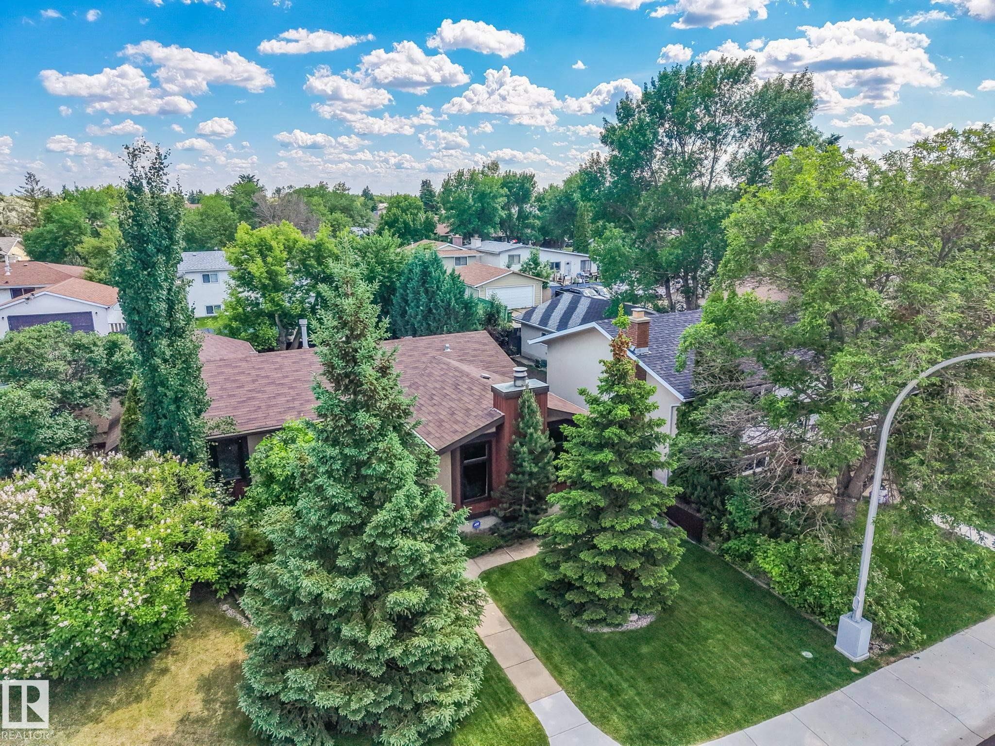 Residential property featuring a shingle roof and a prominent brick chimney - 17237 104 Street, Edmonton, AB