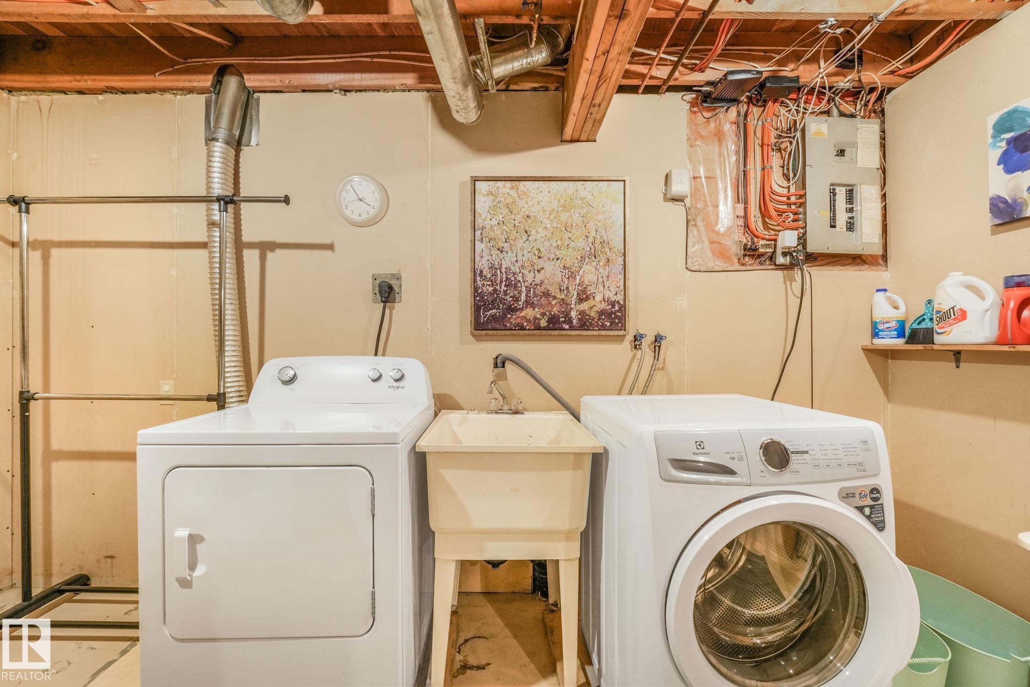 Laundry area featuring exposed wood ceiling joists and concrete flooring - 17237 104 Street, Edmonton, AB