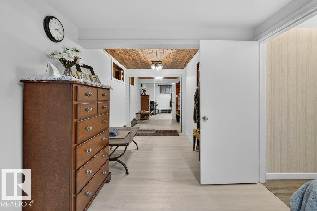Recessed lighting illuminates the wood-finish ceiling, complementing the light wood-finish flooring - 6916 92A Avenue, Edmonton, AB