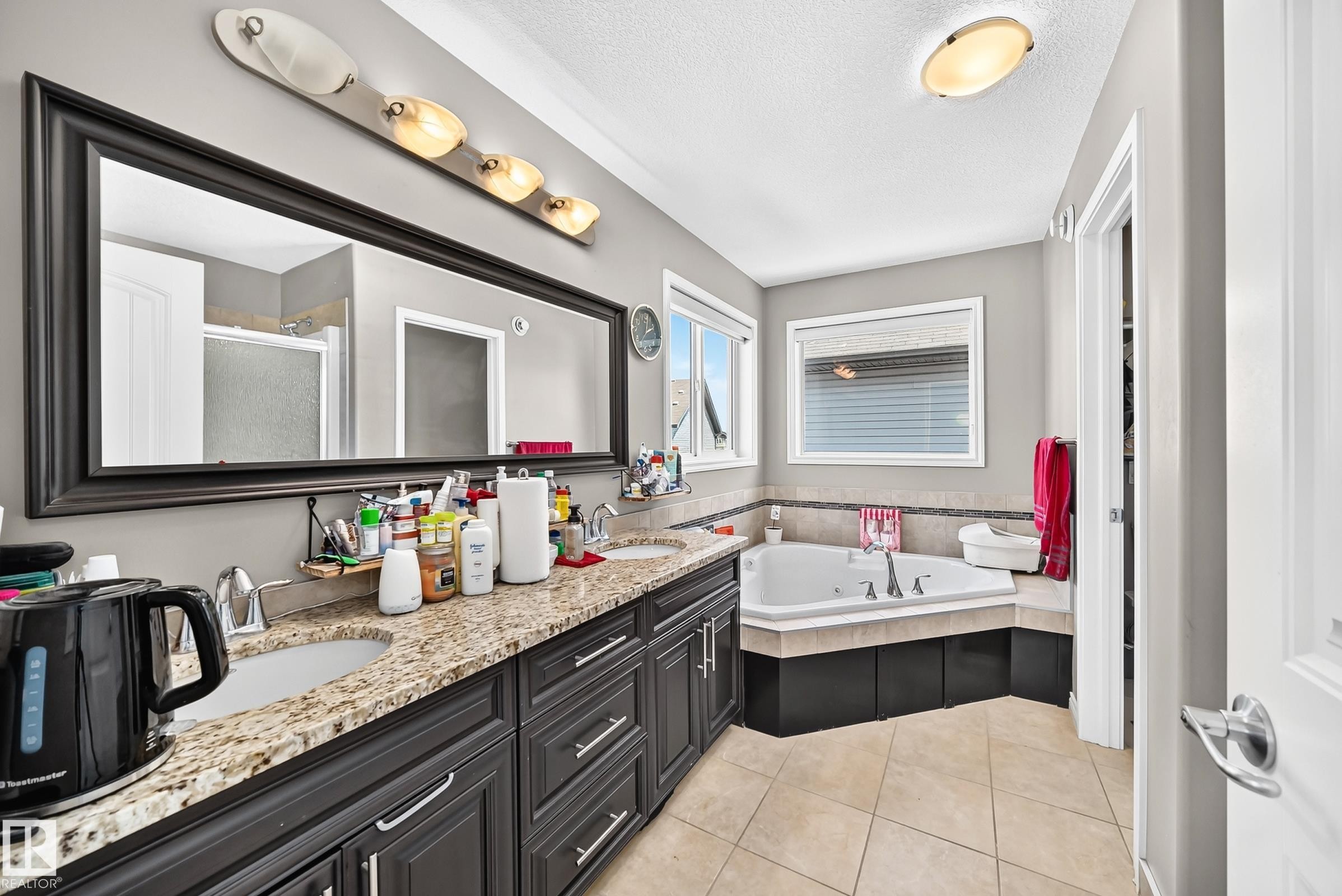 Dual vanity with granite-style countertop and dark wood cabinetry - 12410 171A Avenue, Edmonton, AB