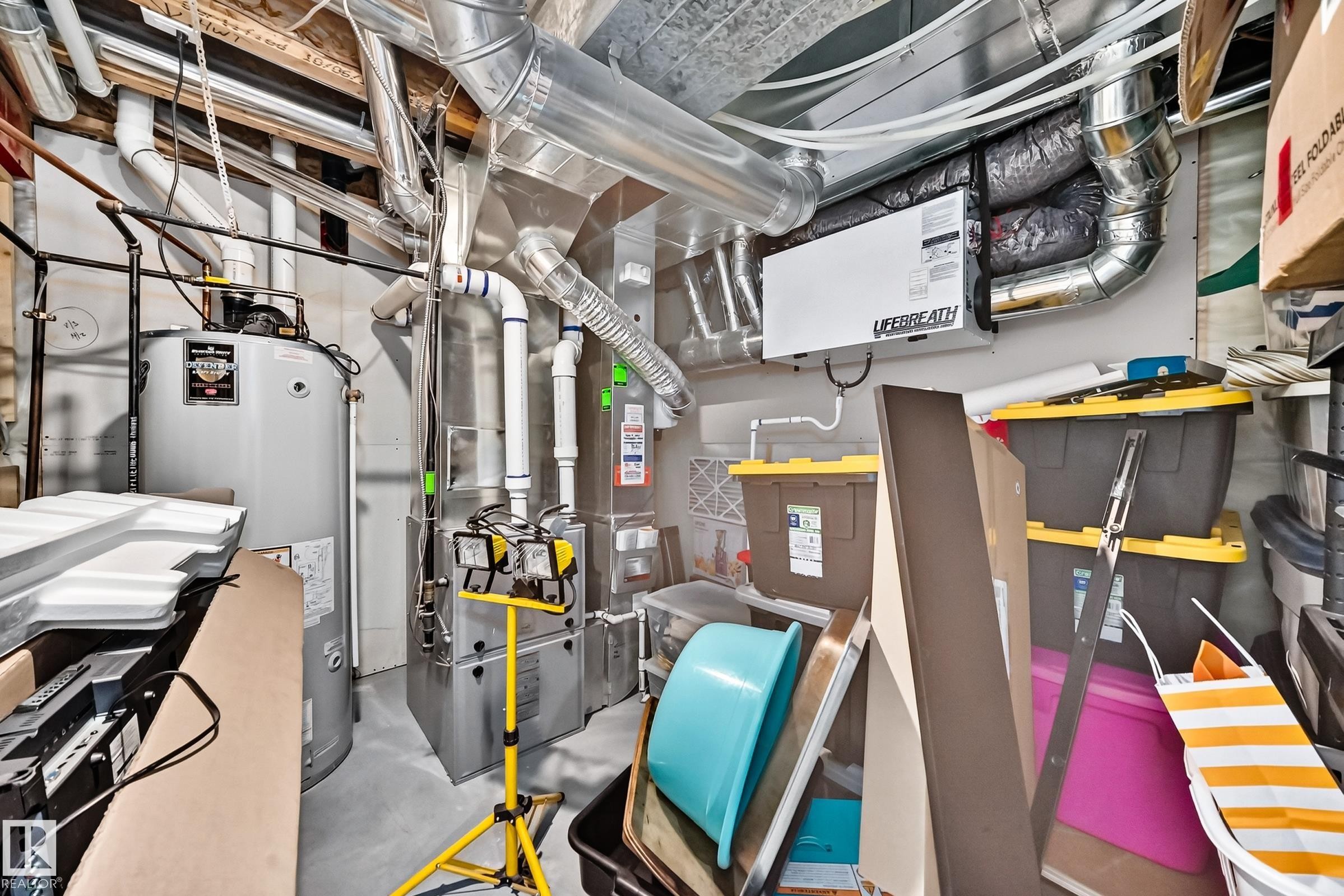 Utility area featuring a water heater, furnace system, extensive ductwork, and a Lifebreath air exchange unit - 12410 171A Avenue, Edmonton, AB