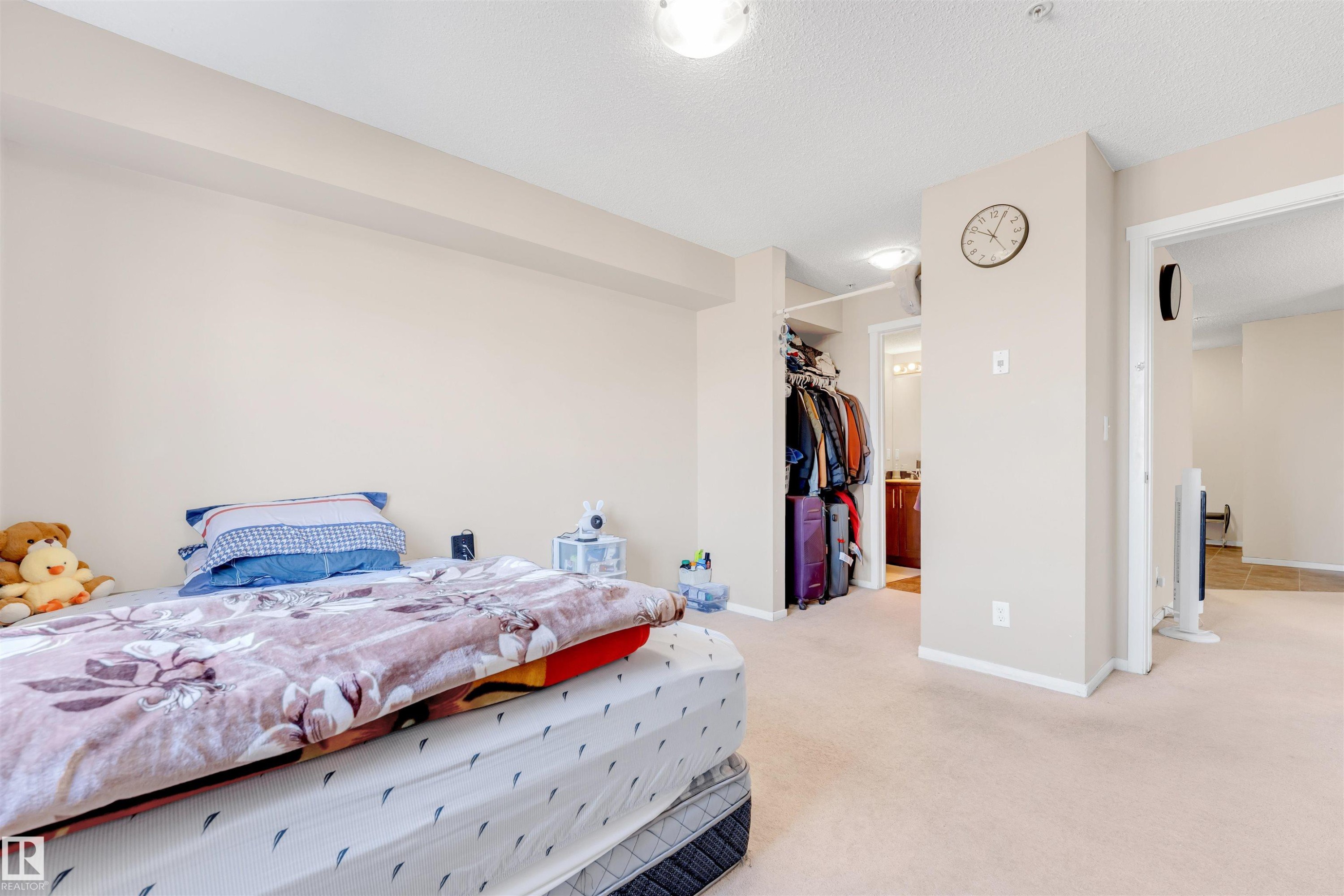 Carpeted room featuring light-colored walls and a recessed ceiling light - 225 111 Watt Common, Edmonton, AB