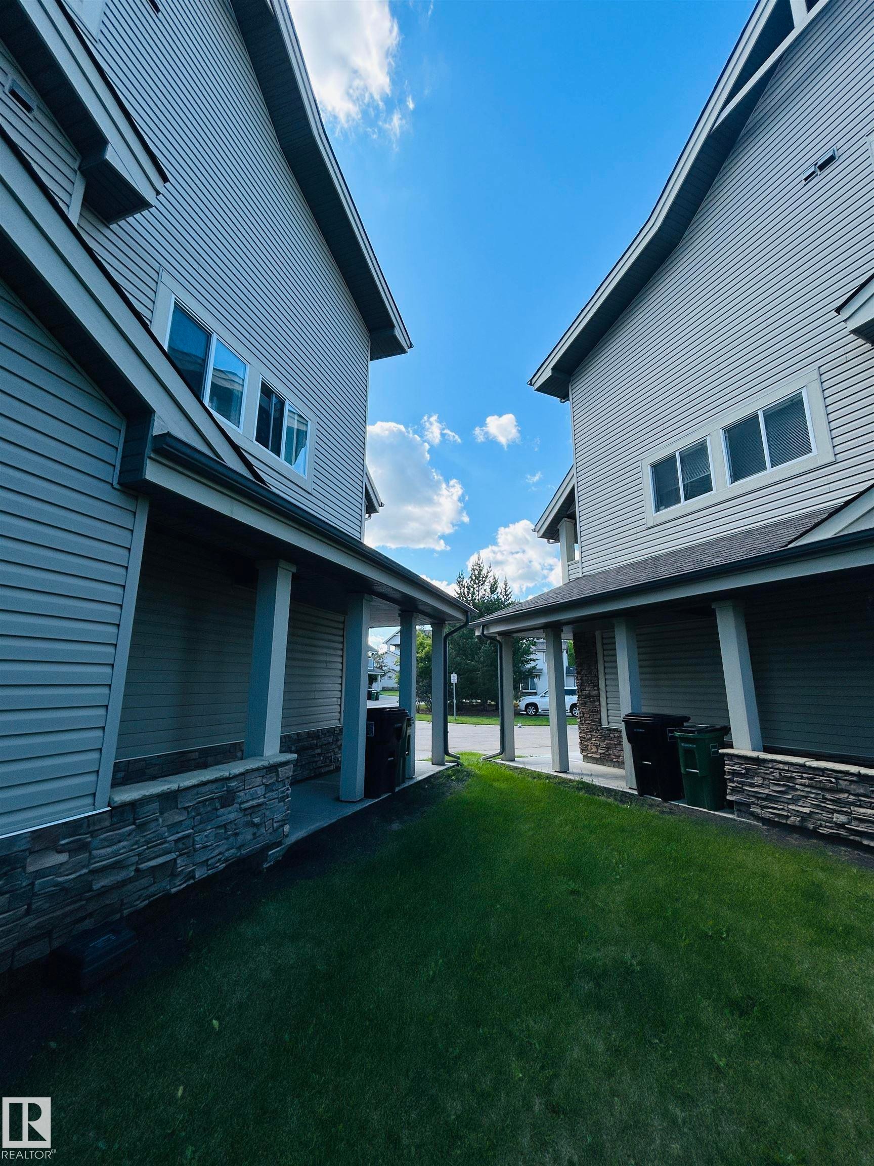 Siding exterior with stone accents and covered entryways - 89 12050 17 Avenue, Edmonton, AB