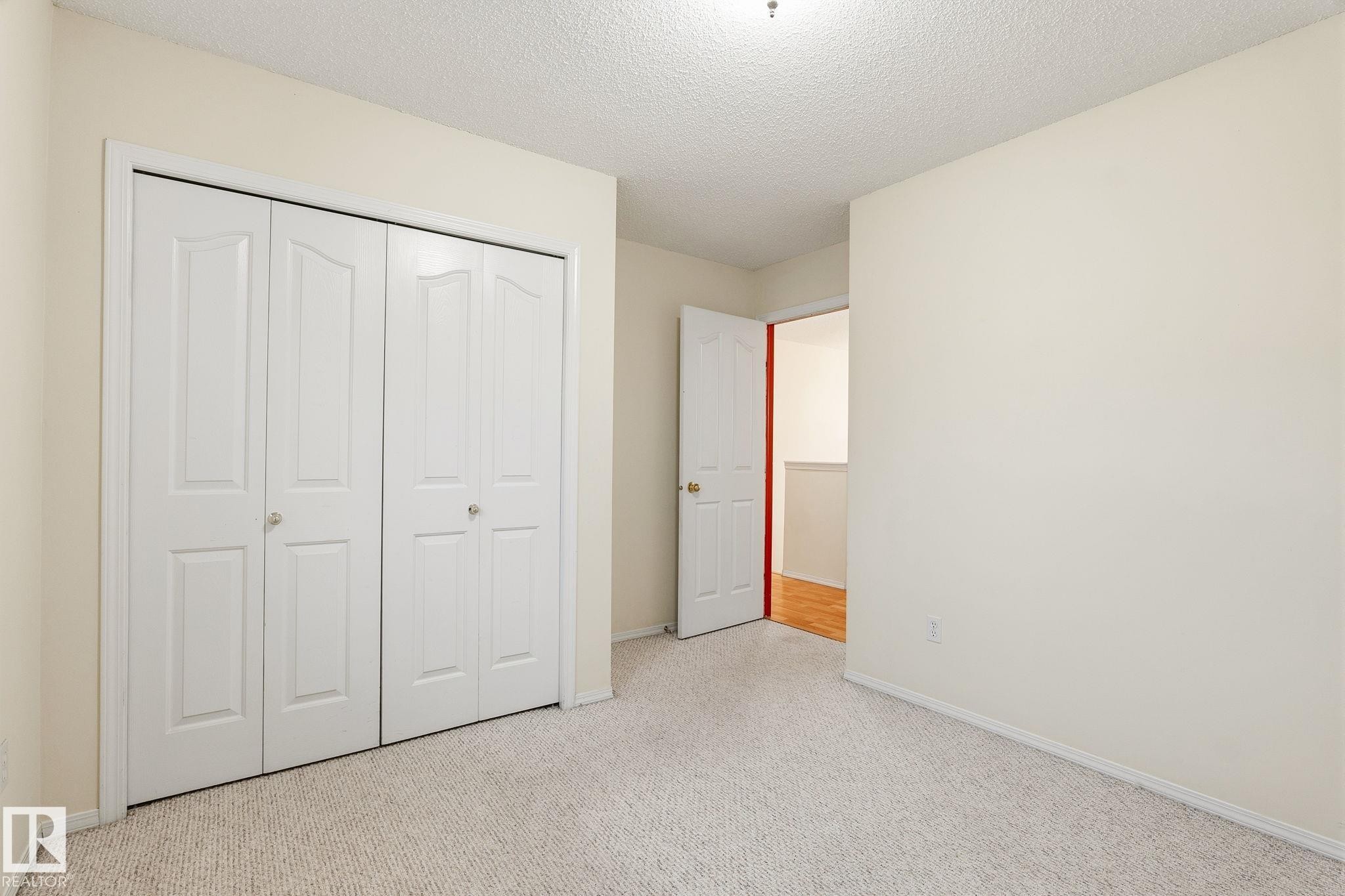 Recessed bi-fold closet doors provide storage - 1906 37B Av Nw, Edmonton, AB - Indoor