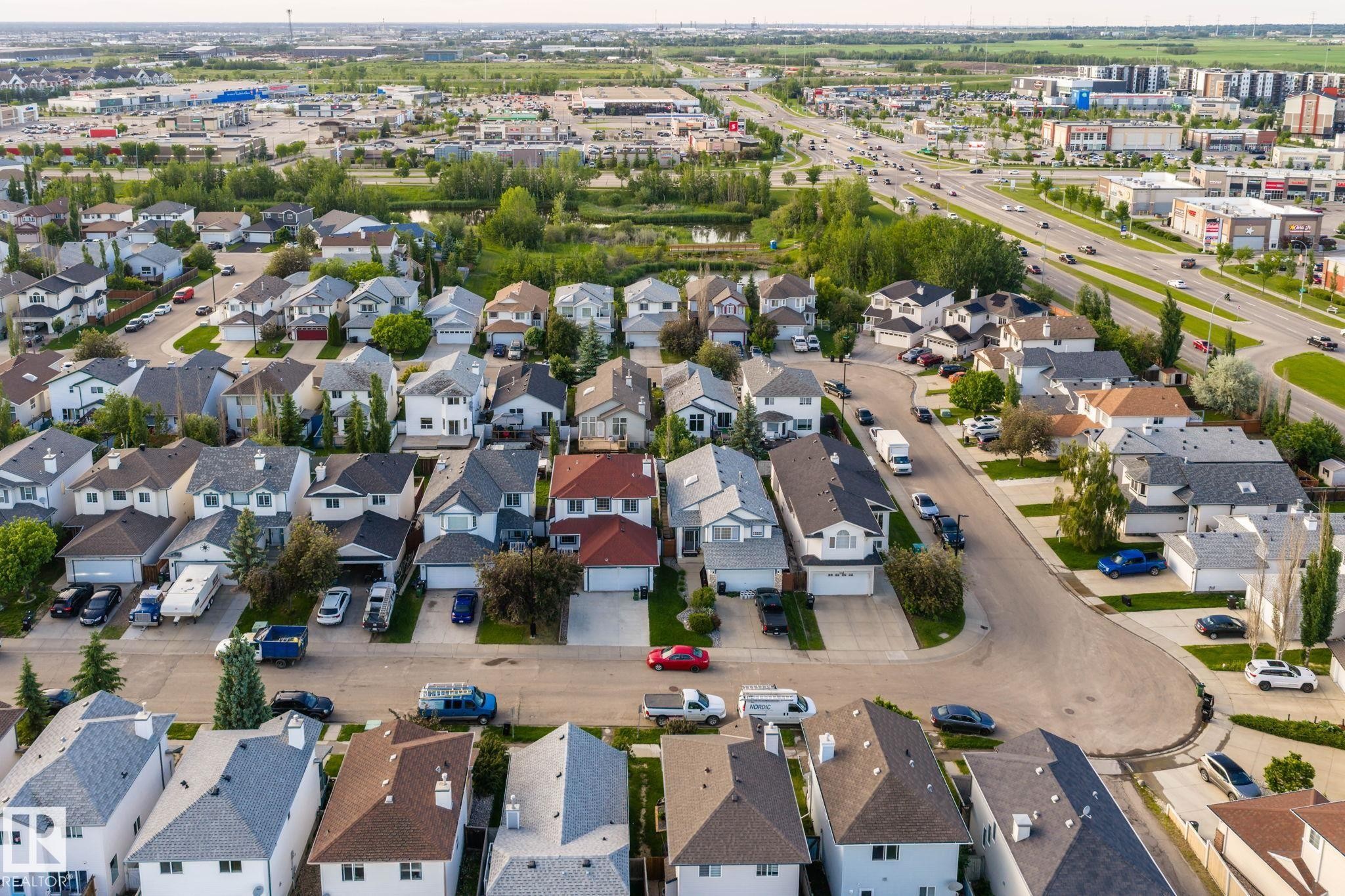 Residential neighborhood featuring detached homes with attached garages, paved streets, and varied rooflines - 1906 37B Av Nw, Edmonton, AB - Outdoor With View