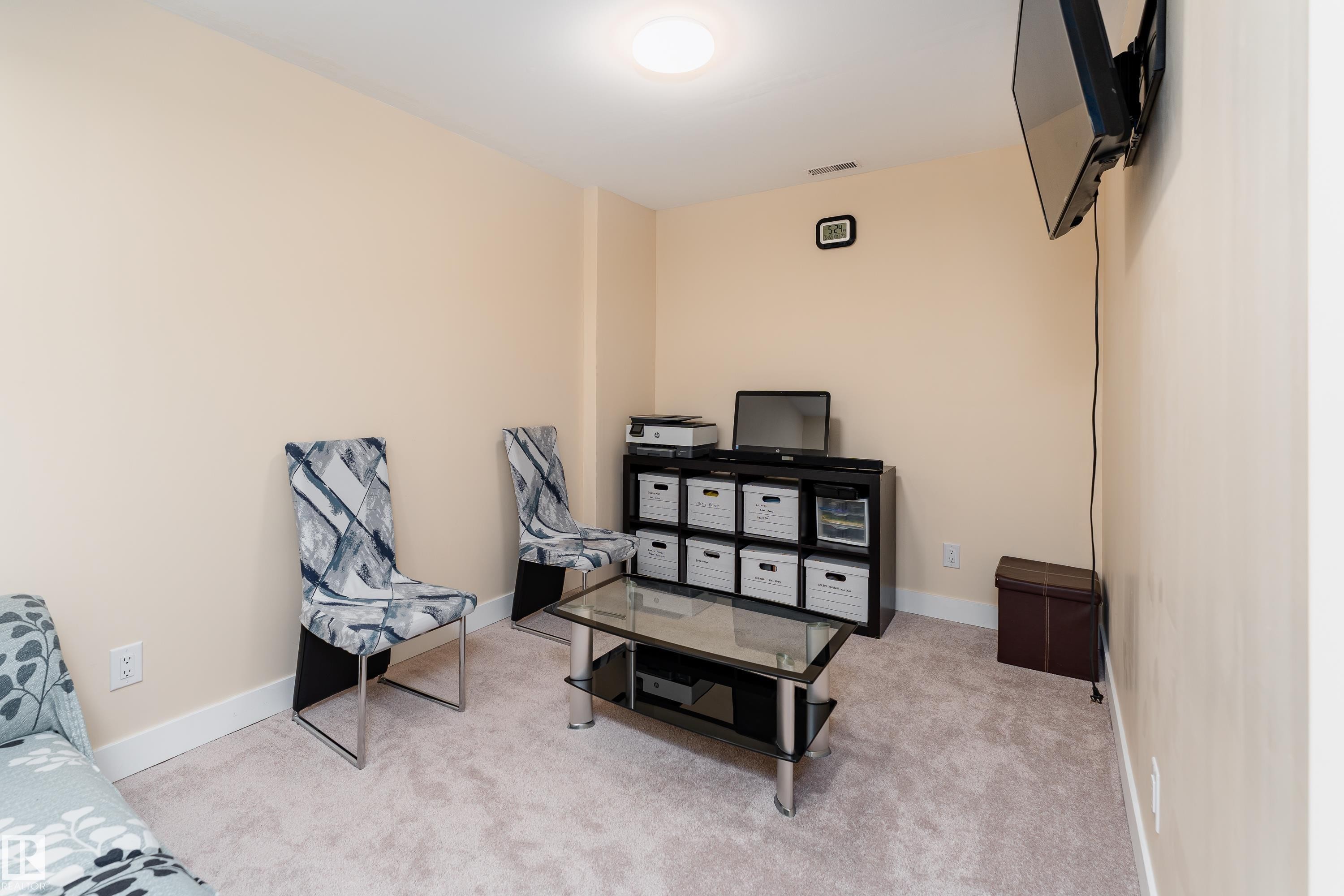 Carpeted room with light-toned walls and white baseboards - 191 Reed Place, Leduc, AB - Indoor