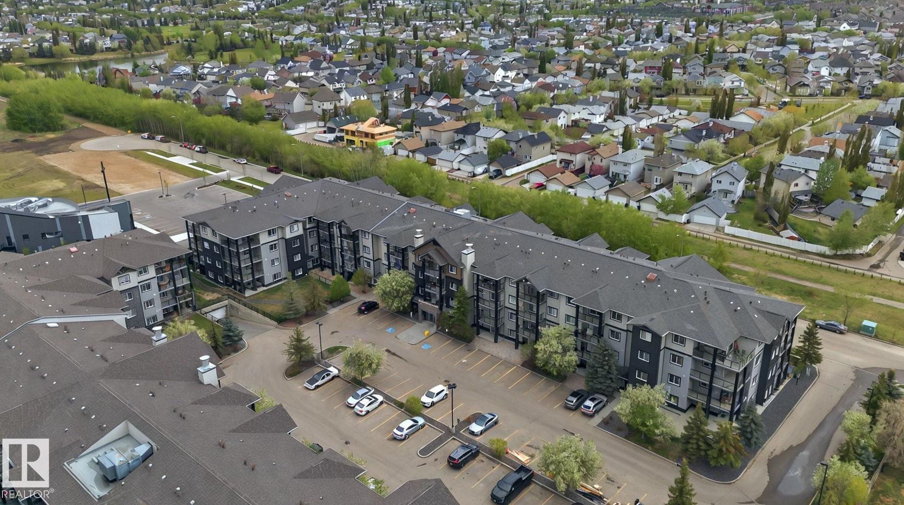 Multi-story apartment building featuring dark grey siding and light grey accents - 117 1204 156 Street, Edmonton, AB -