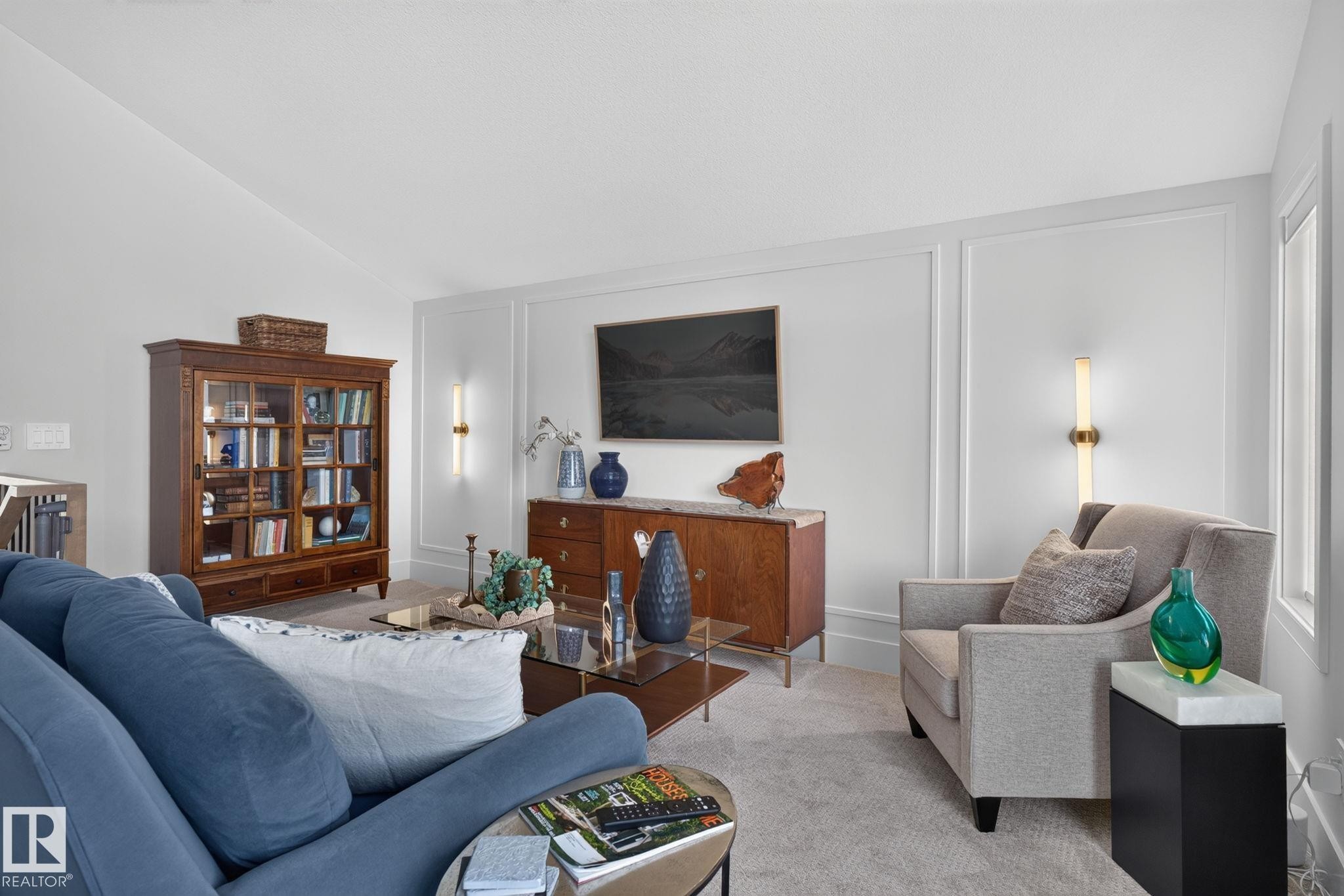 Interior living space featuring light-toned carpeting and white walls with decorative molding - 14 Jane Point(E), St. Albert, AB