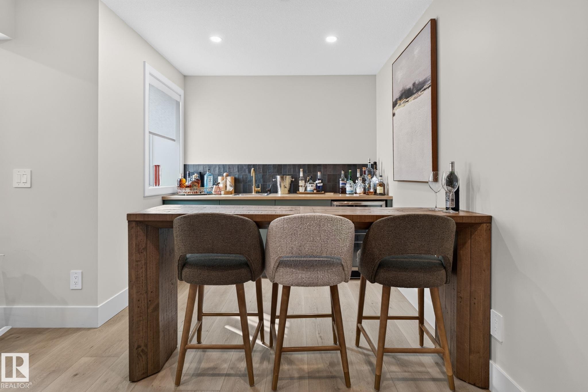 Wet bar featuring a wood-finish countertop, dark tile backsplash, and a built-in beverage refrigerator - 14 Jane Point(E), St. Albert, AB