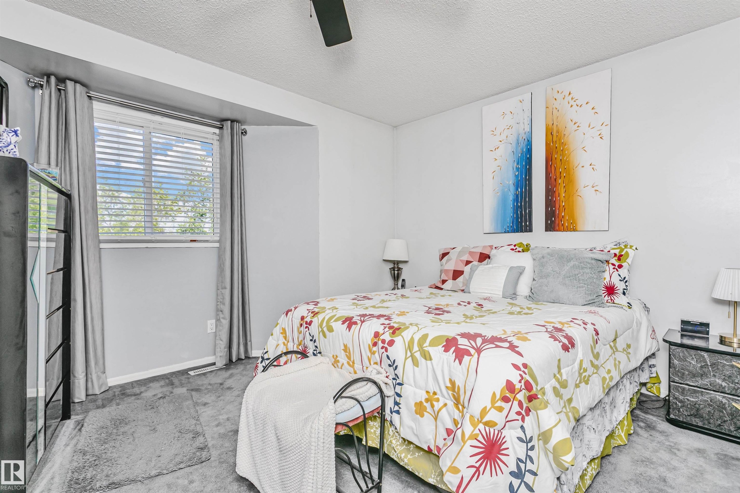 Carpeted bedroom with a window featuring horizontal blinds and drapery - 1612 80A Street, Edmonton, AB