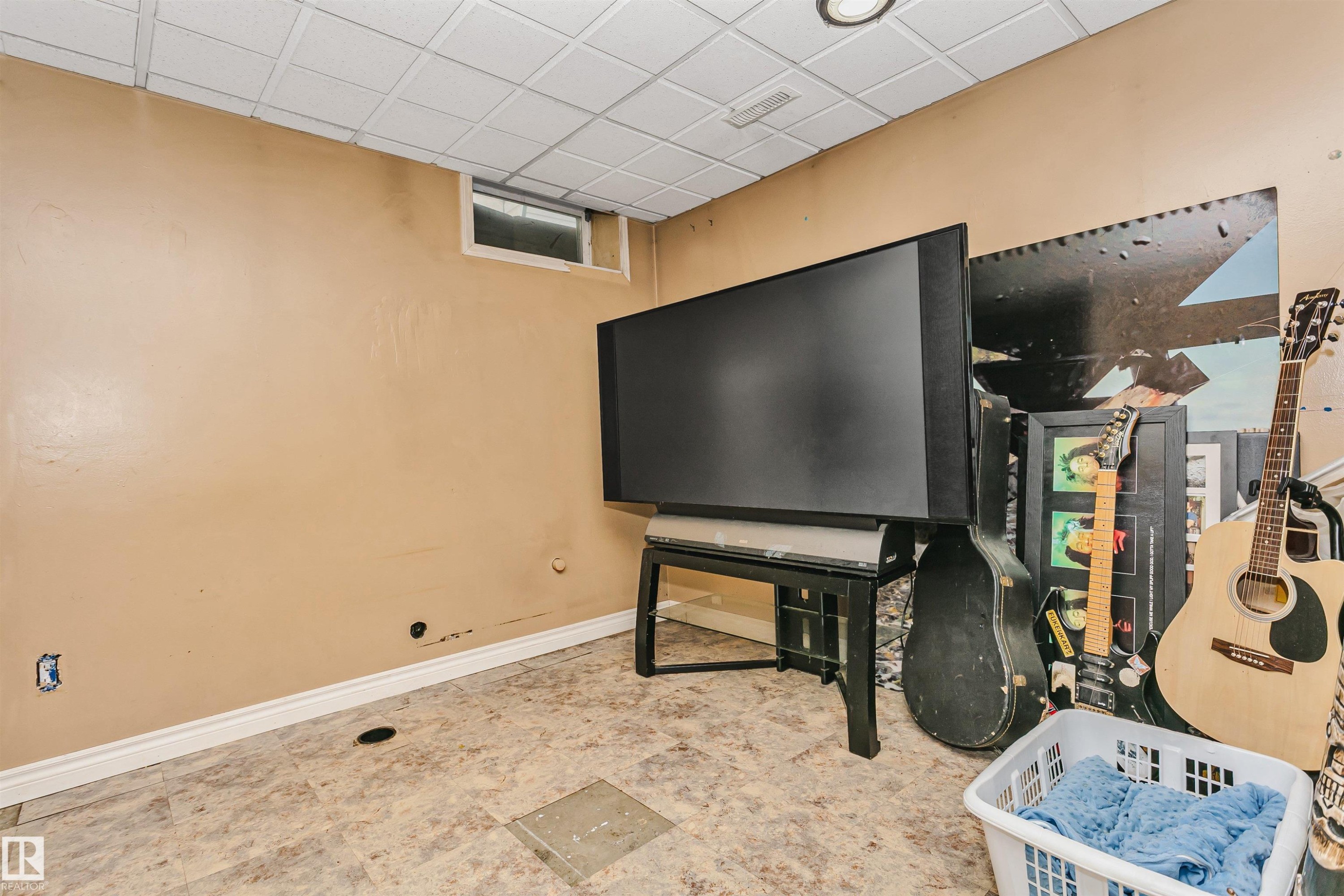 Room featuring a drop ceiling, single window, and light-toned walls - 1612 80A Street, Edmonton, AB