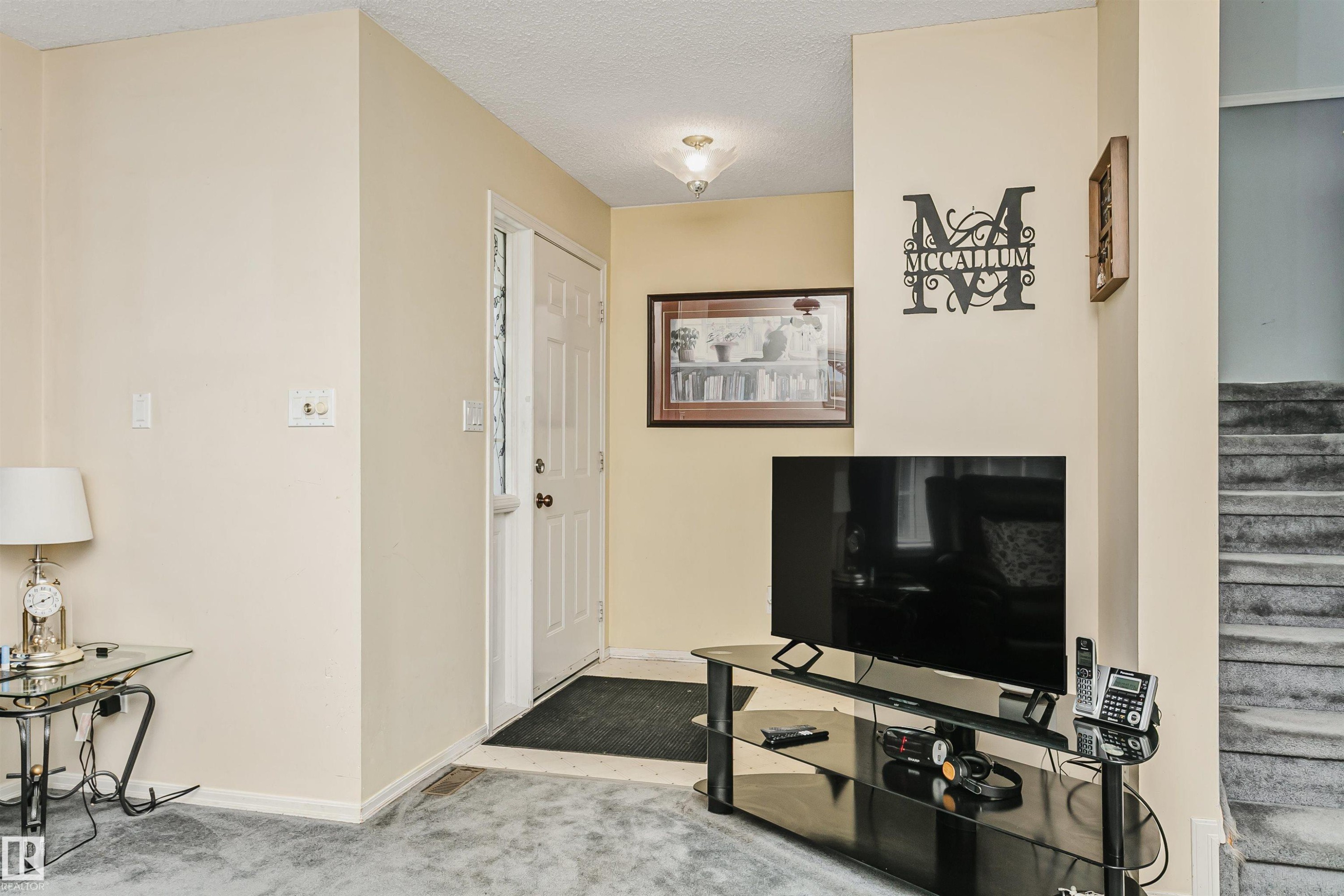 Entryway featuring a paneled door, ceiling-mounted light fixture, and tile flooring - 1612 80A Street, Edmonton, AB