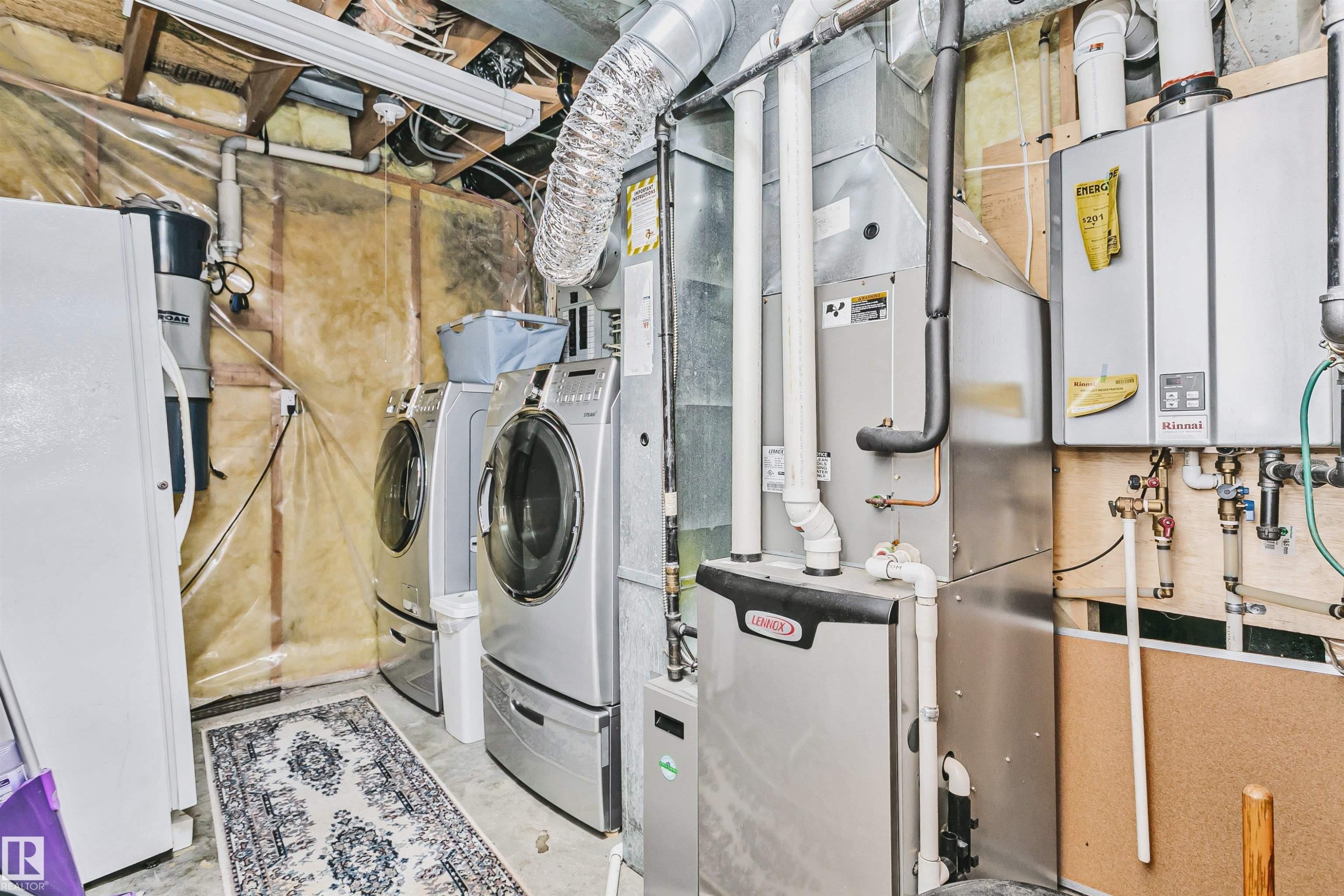 Laundry area featuring a side-by-side washer and dryer, a hot water heater, and a furnace unit - 1612 80A Street, Edmonton, AB