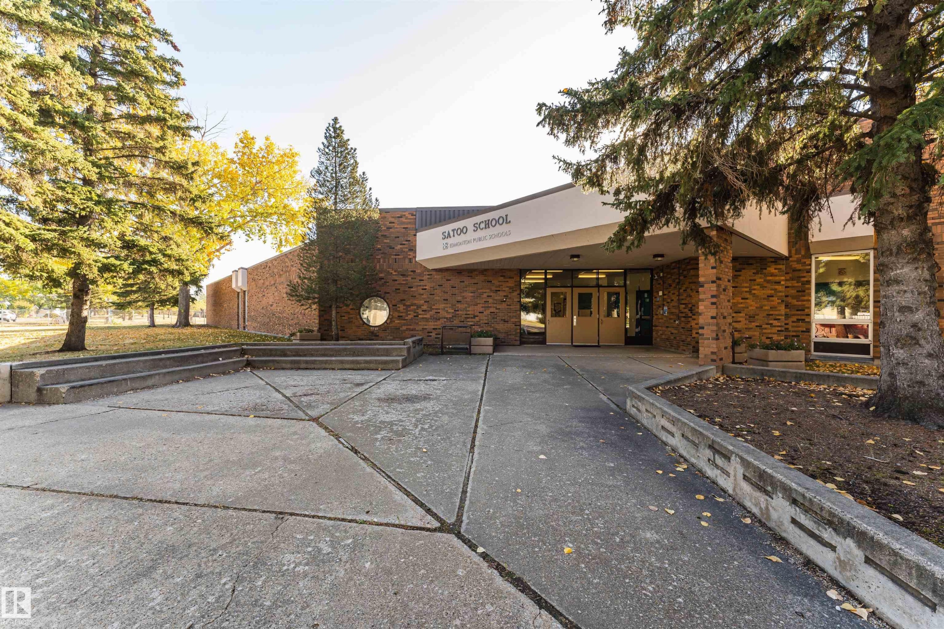 Brick exterior building featuring multiple entryways and large windows - 1612 80A Street, Edmonton, AB