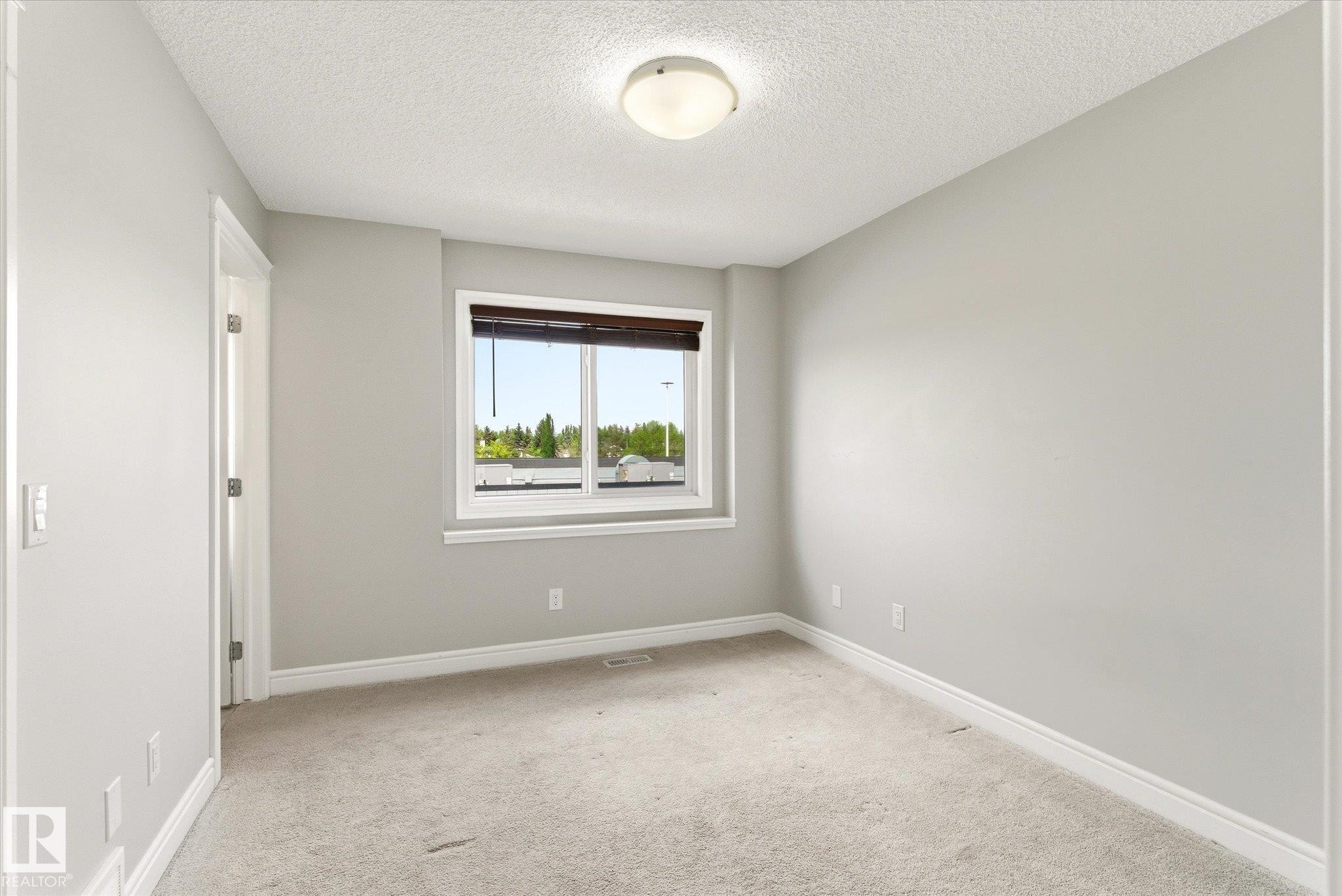 Room featuring neutral gray walls and light-colored carpeting - 47 330 Bulyea Road, Edmonton, AB - Indoor Photo Showing Other Room