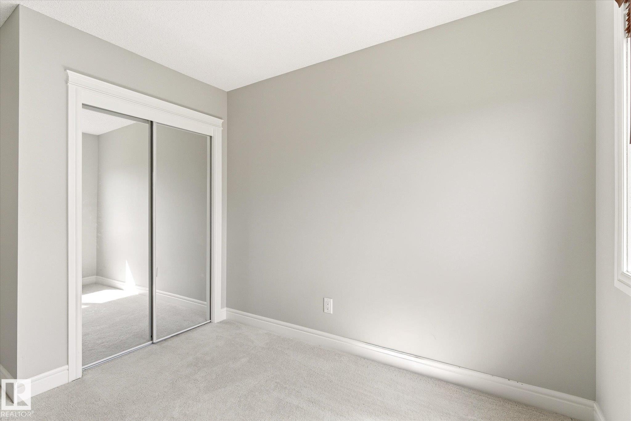 Room featuring light gray wall paint, white trim, and light gray carpet - 47 330 Bulyea Road, Edmonton, AB - Indoor Photo Showing Other Room