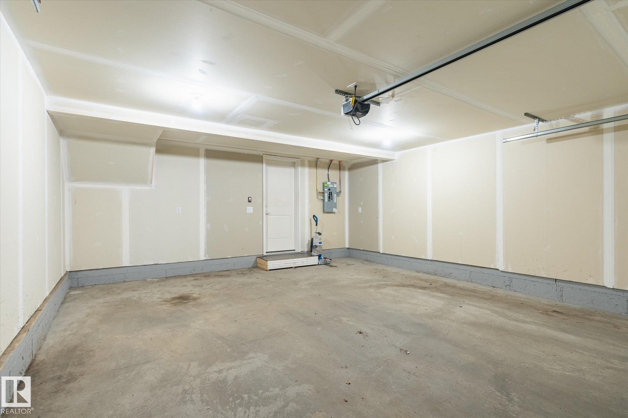 Spacious garage with concrete flooring and exposed drywall - 47 330 Bulyea Road, Edmonton, AB - Indoor Photo Showing Garage