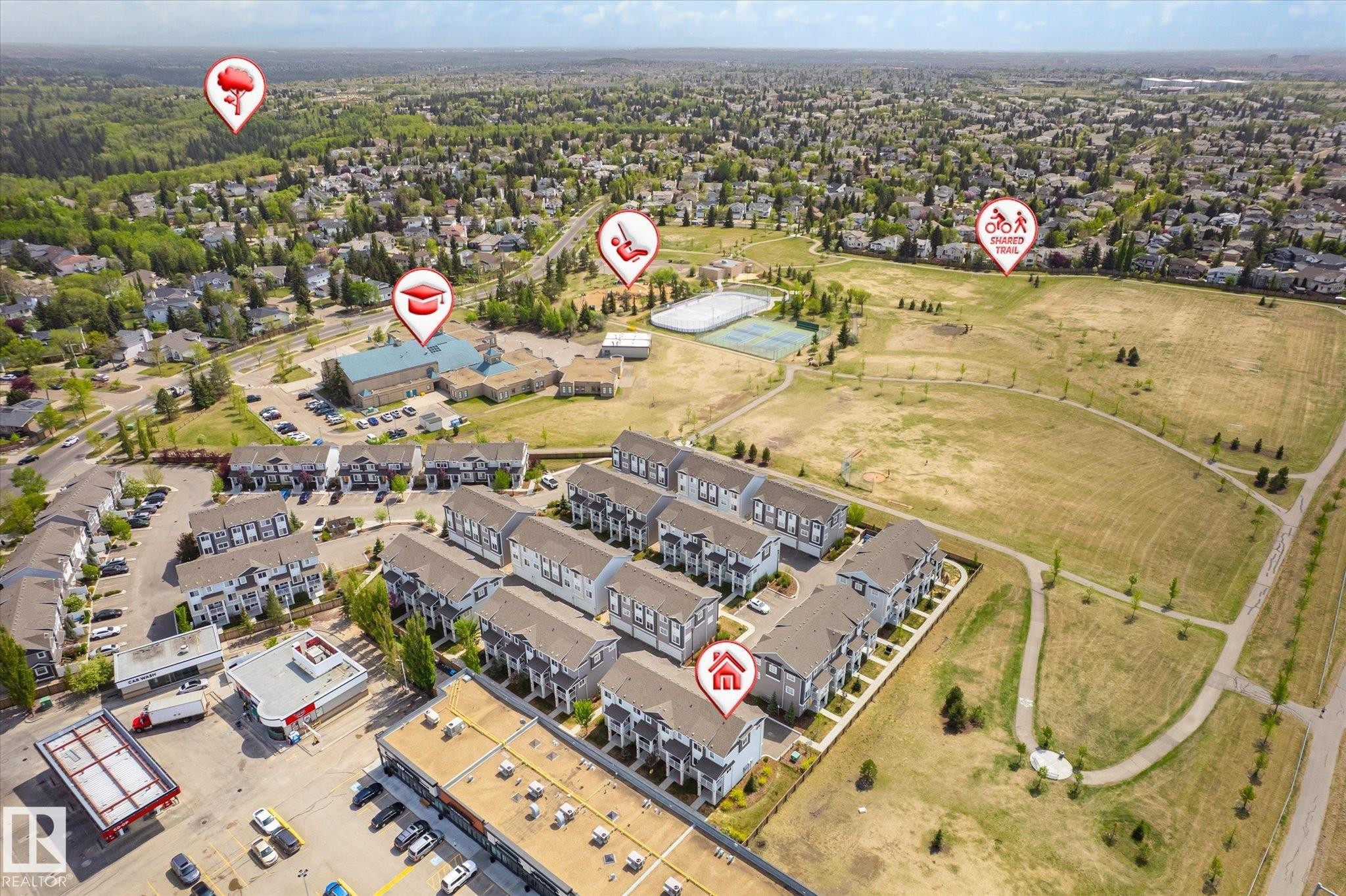 Aerial perspective showcasing a community of multi-story residences with dark roofs and light-colored siding - 47 330 Bulyea Road, Edmonton, AB - With View