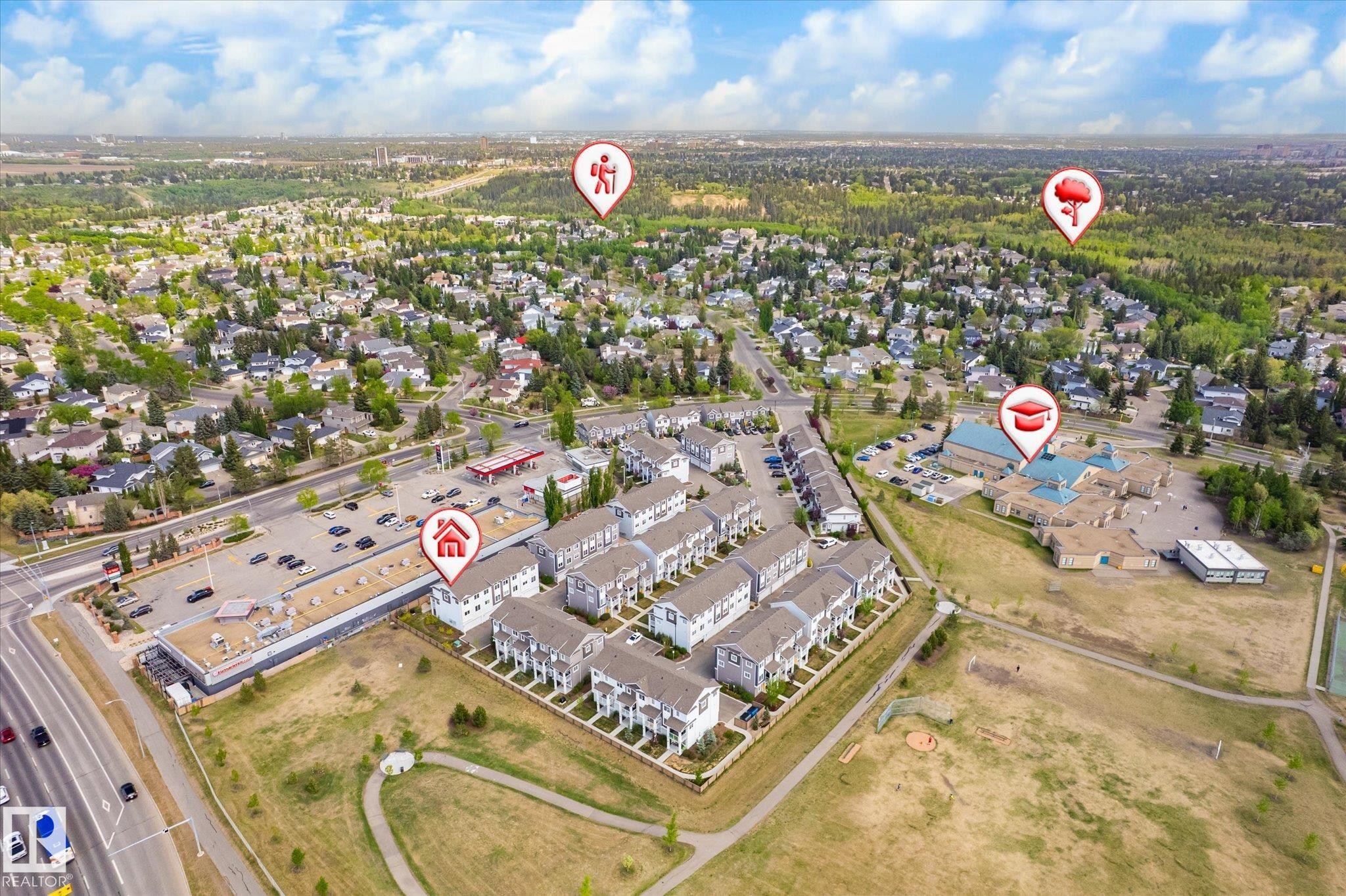 Aerial perspective showcasing a residential development with structured landscaping, adjacent to a commercial strip and a large educational facility - 47 330 Bulyea Road, Edmonton, AB - Outdoor With View