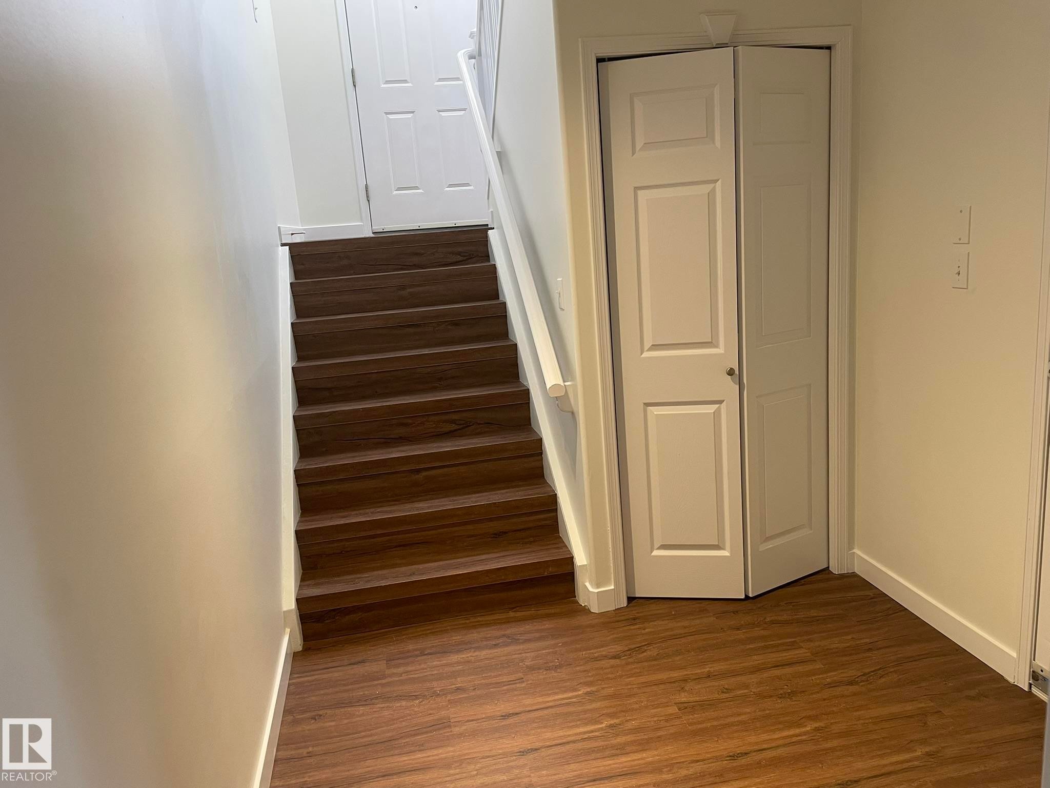 Interior staircase featuring wood-finish treads and risers with a white handrail - 2 1295 Carter Crest Road, Edmonton, AB - Indoor Photo Showing Other Room