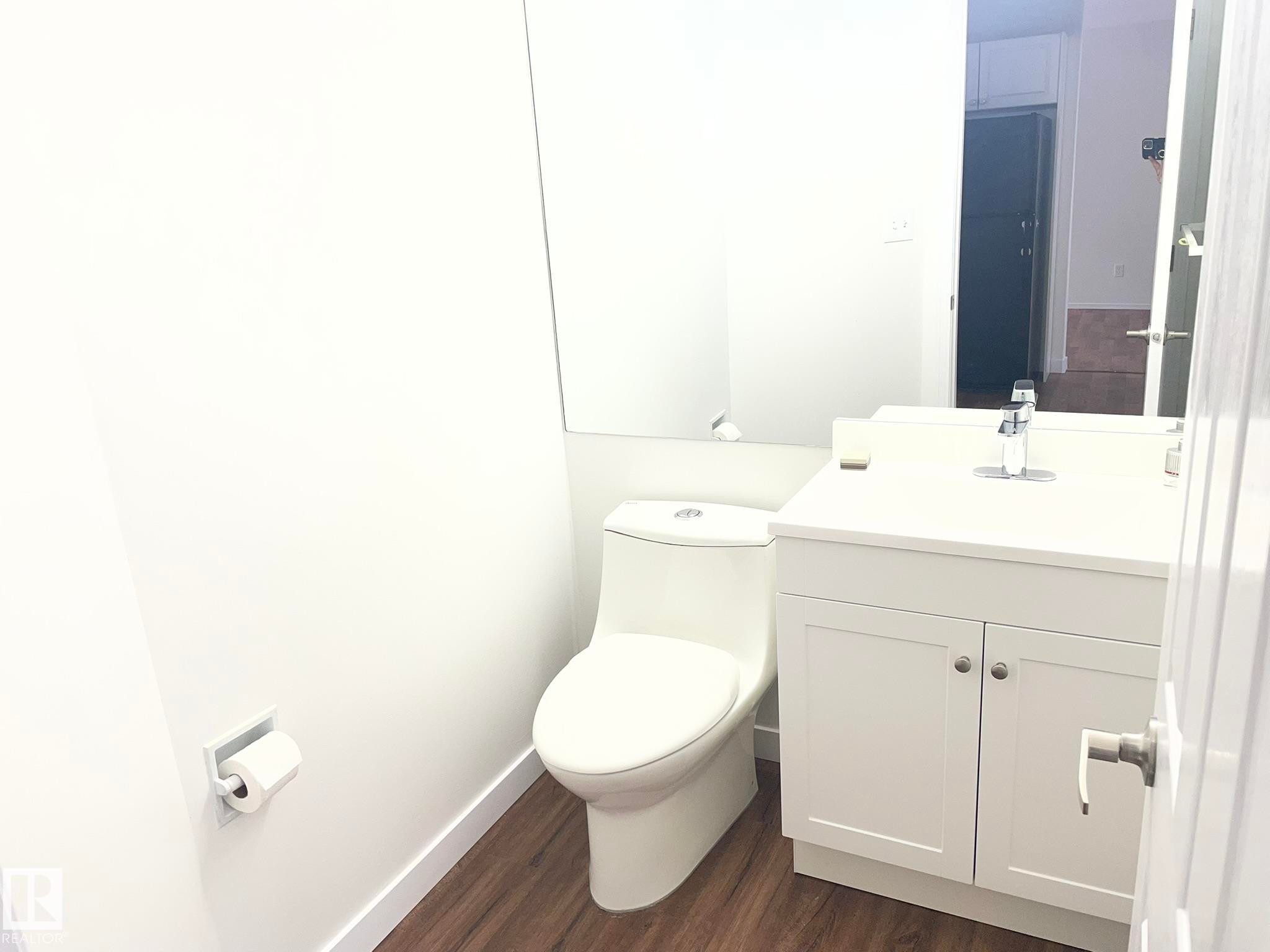 Bathroom featuring a white vanity with silver hardware, an integrated sink, and a chrome faucet - 2 1295 Carter Crest Road, Edmonton, AB - Indoor Photo Showing Bathroom
