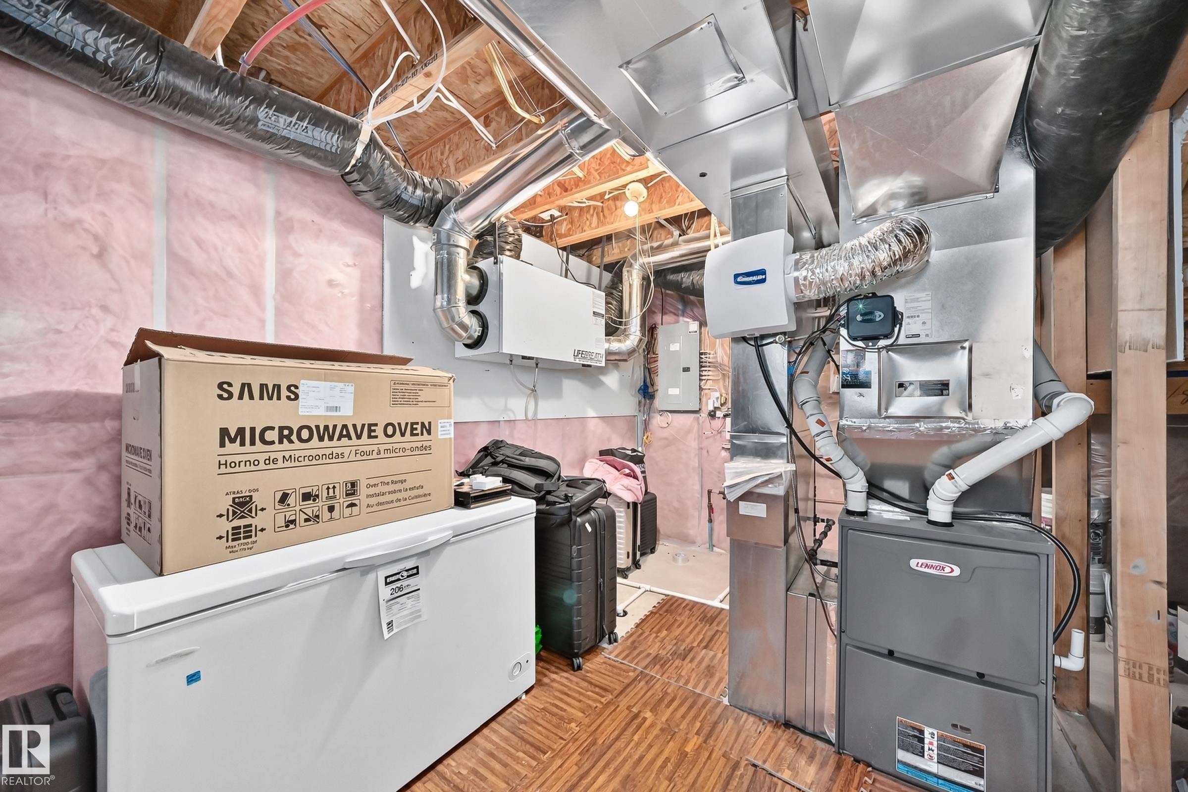 Mechanical room featuring a Lennox furnace, humidifier, exposed ductwork, and ceiling joists - 3433 Goodridge Link Link, Edmonton, AB