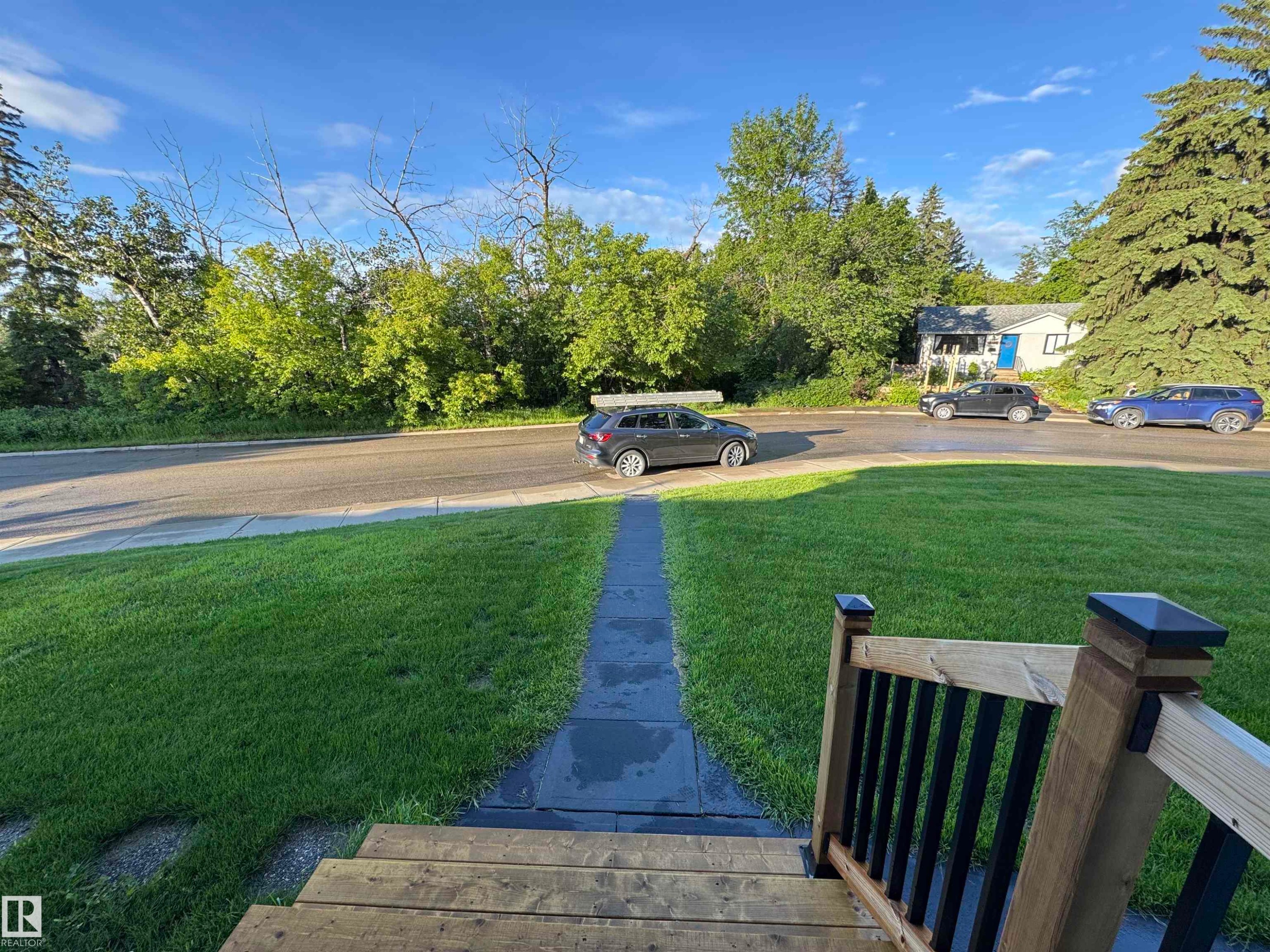 Boasting a lush front lawn, the property is directly across from Fulton Ravine, providing gorgeous year-round views from both inside and out of the home - 10328 73 Street, Edmonton, AB