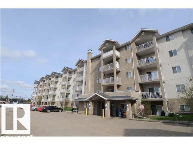 Multi-story residential building with private balconies and a covered main entrance - 116 10535 122 Street, Edmonton, AB