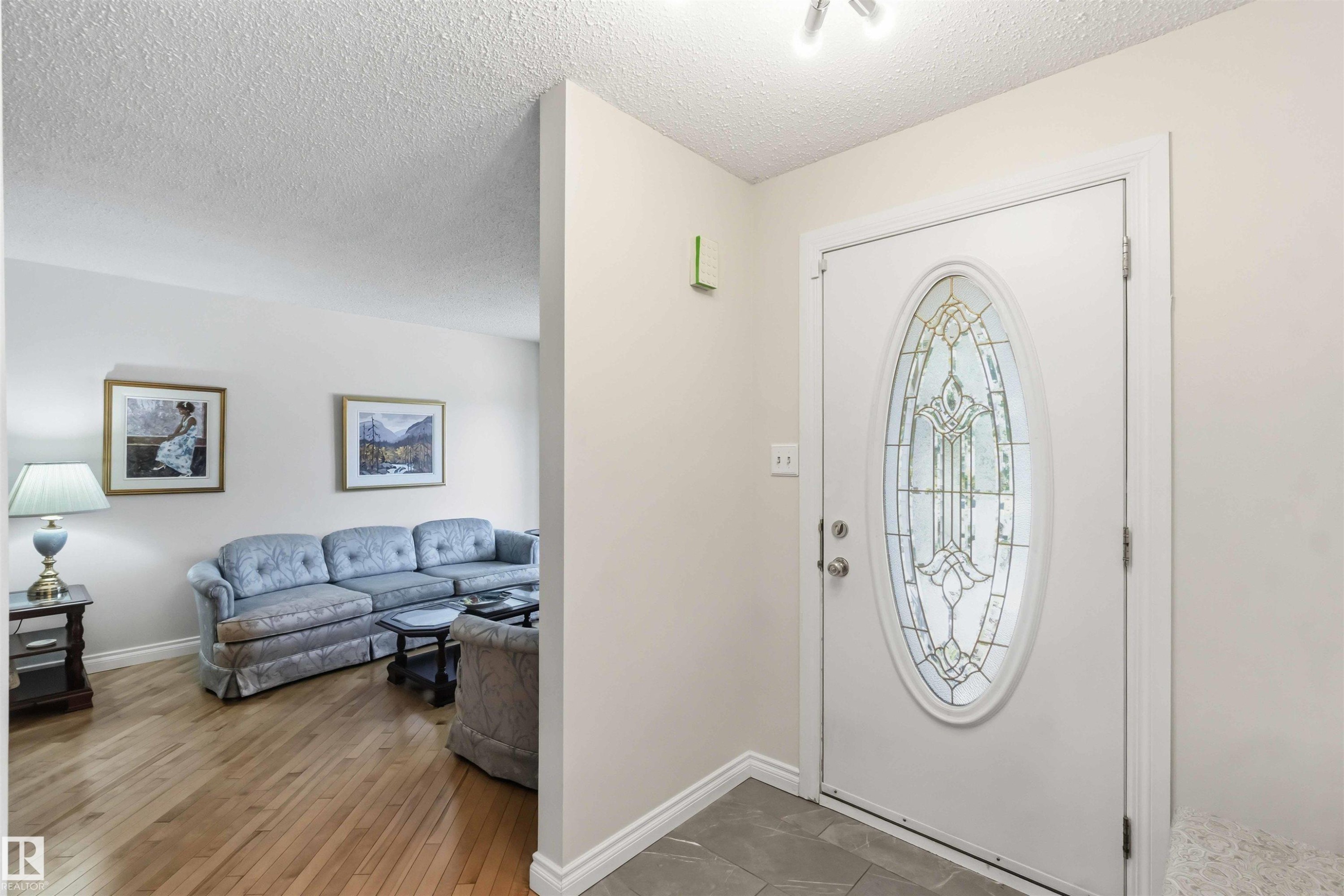 Entry door with decorative oval glass insert - 31 Gariepy Crescent, Edmonton, AB