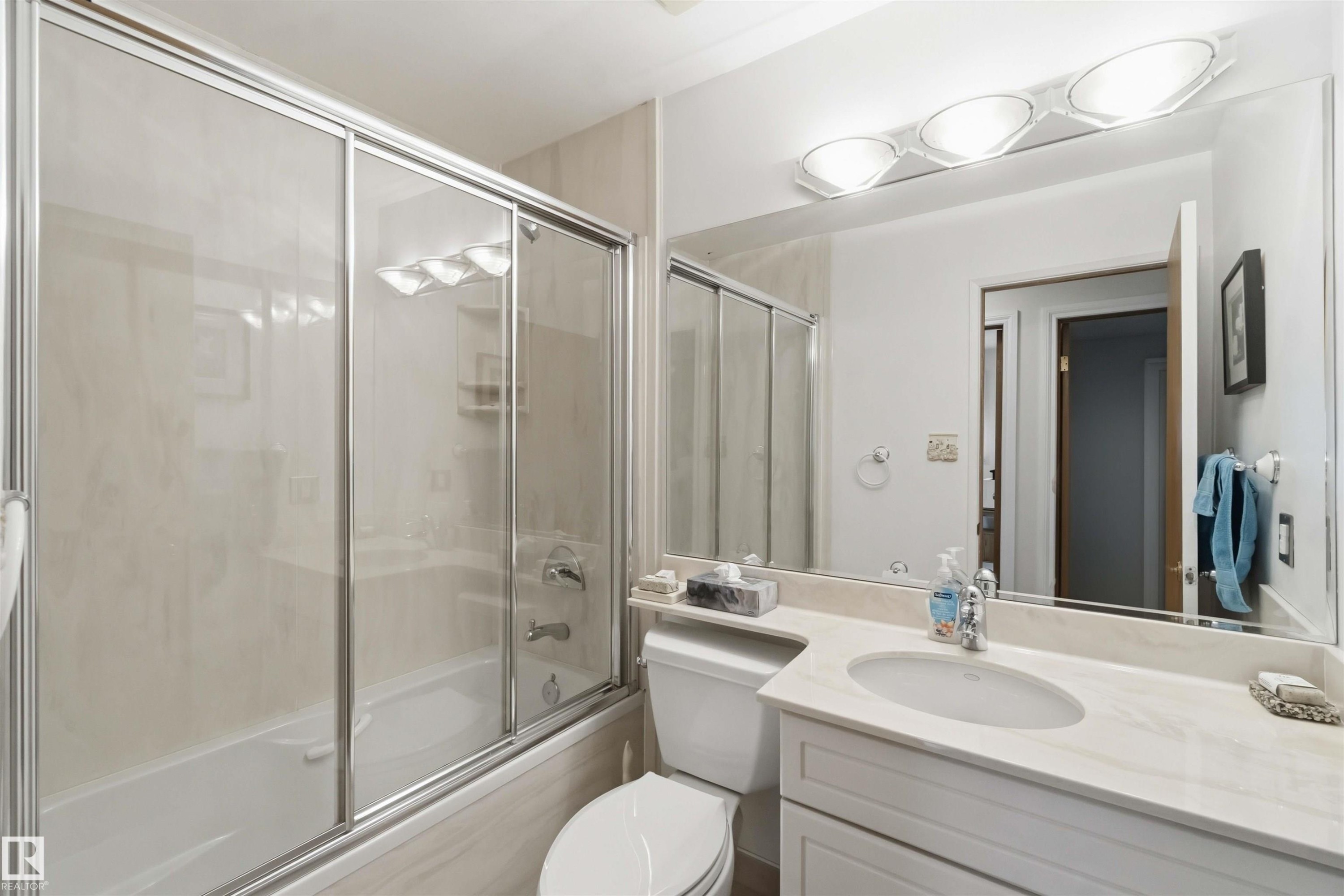 Bathroom with a full bathtub and sliding glass shower doors - 31 Gariepy Crescent, Edmonton, AB