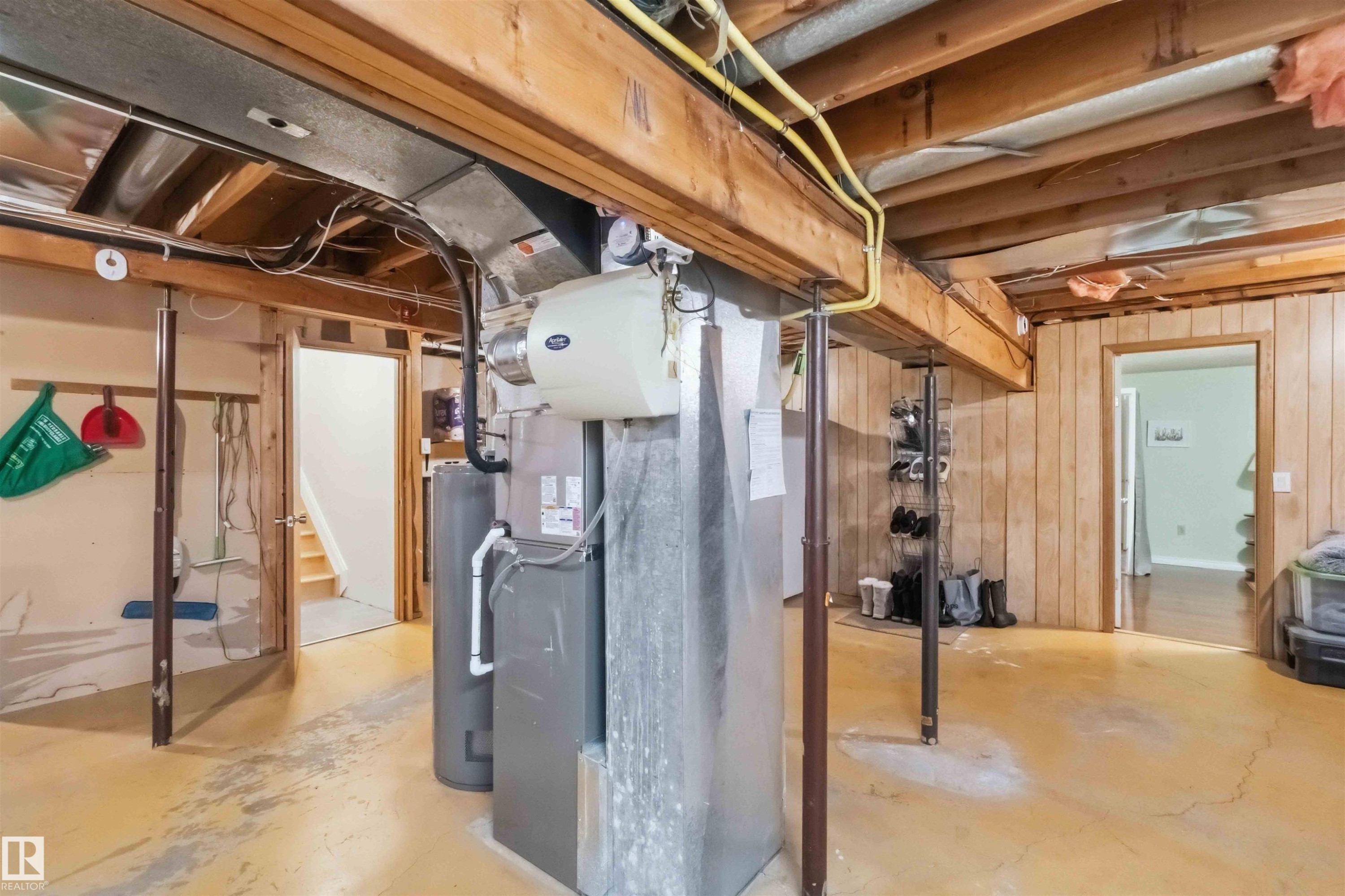 Basement utility area featuring exposed wood joists, structural supports, and accessible mechanical systems - 31 Gariepy Crescent, Edmonton, AB