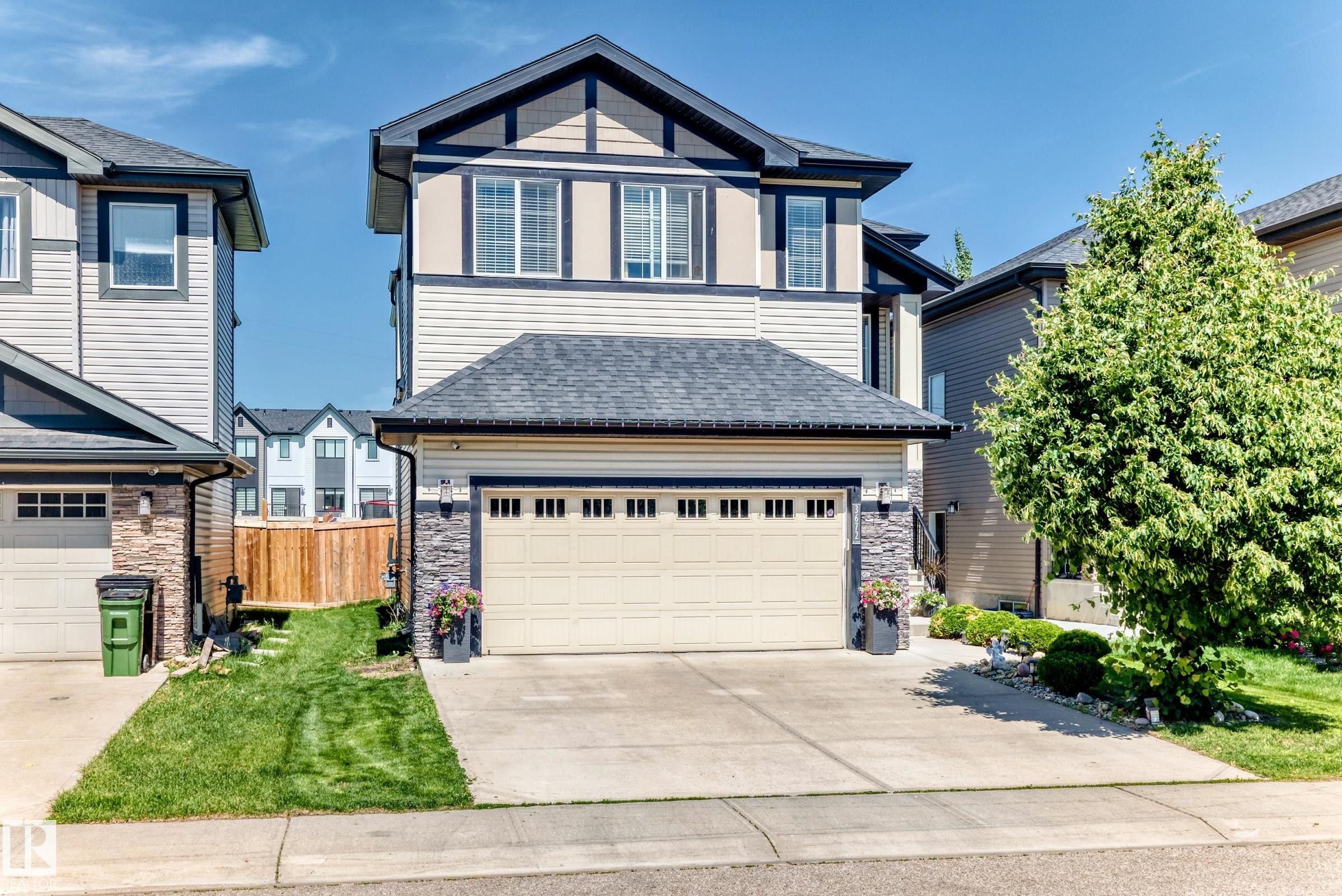 Two-story property featuring light siding and dark trim accents - 3672 Claxton Place Sw, Edmonton, AB